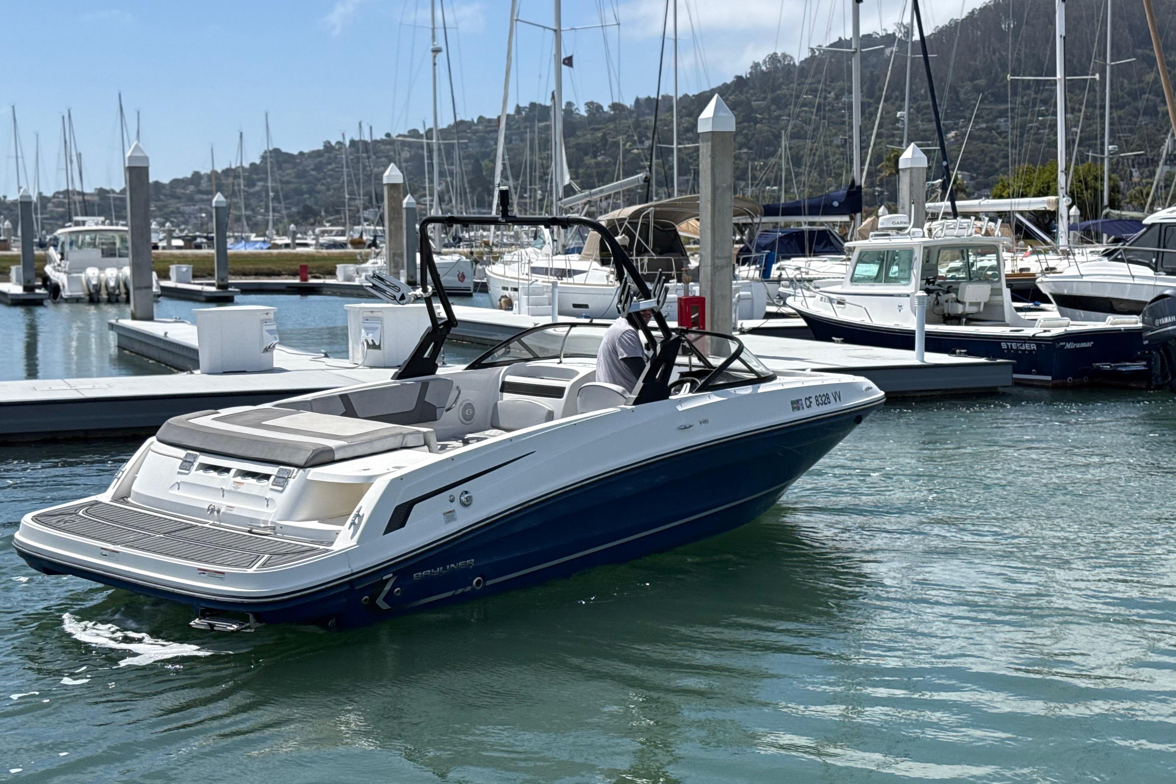 2021 Bayliner VR5 Bowrider I/O docked at a marina with surrounding boats.