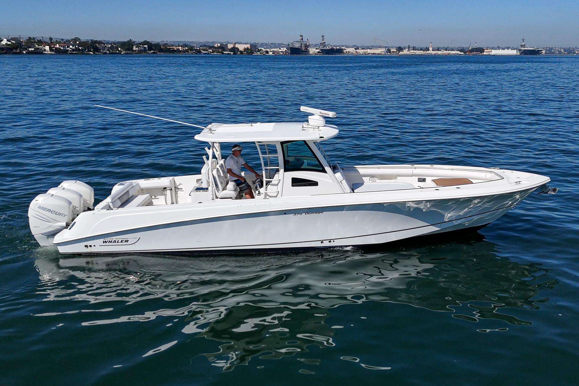 2015 Boston Whaler 370 Outrage boat cruising on calm blue waters.