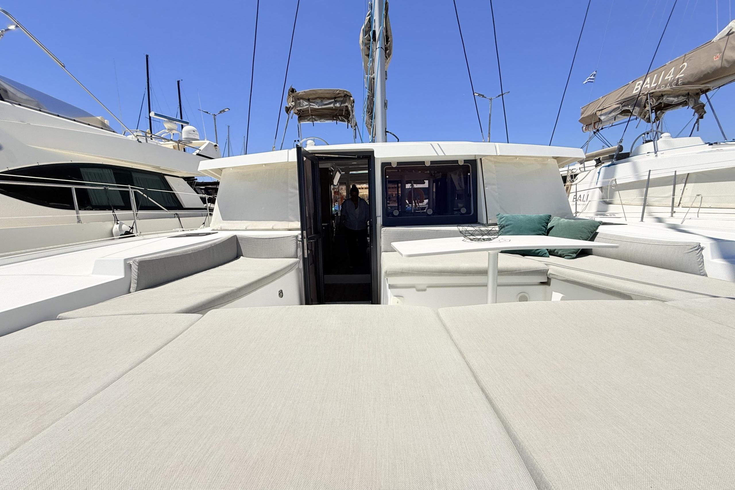 Luxurious 2023 Bali 4.2 yacht with spacious deck and seating area in marina.