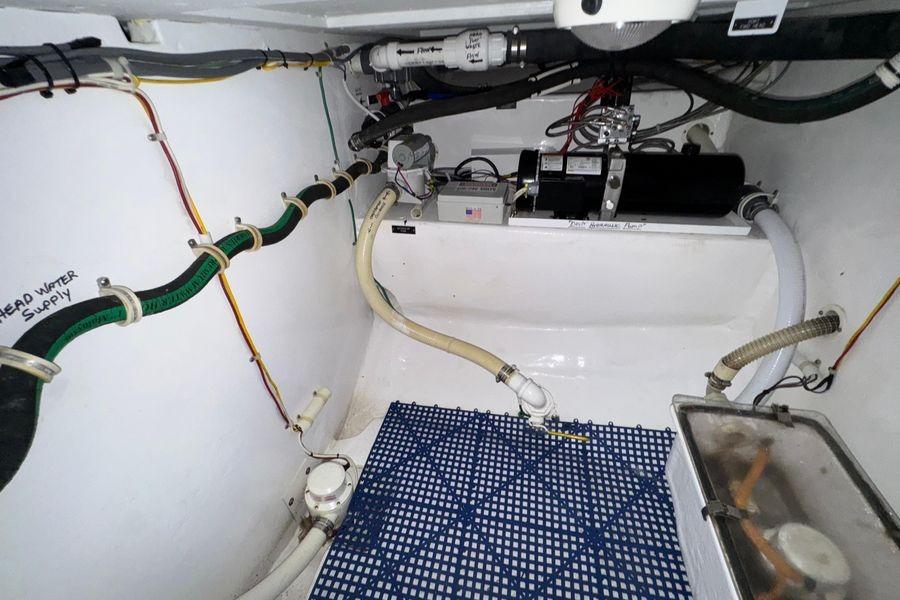 Engine room of 2002 Viking 61 Enclosed Bridge yacht with visible piping and equipment.