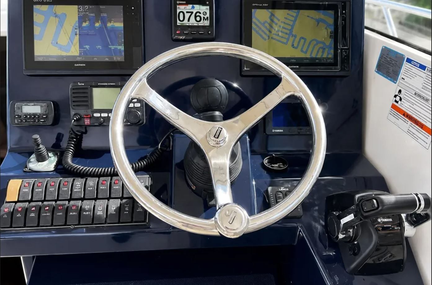 2016 Pursuit OS 325 Offshore helm with navigation systems.