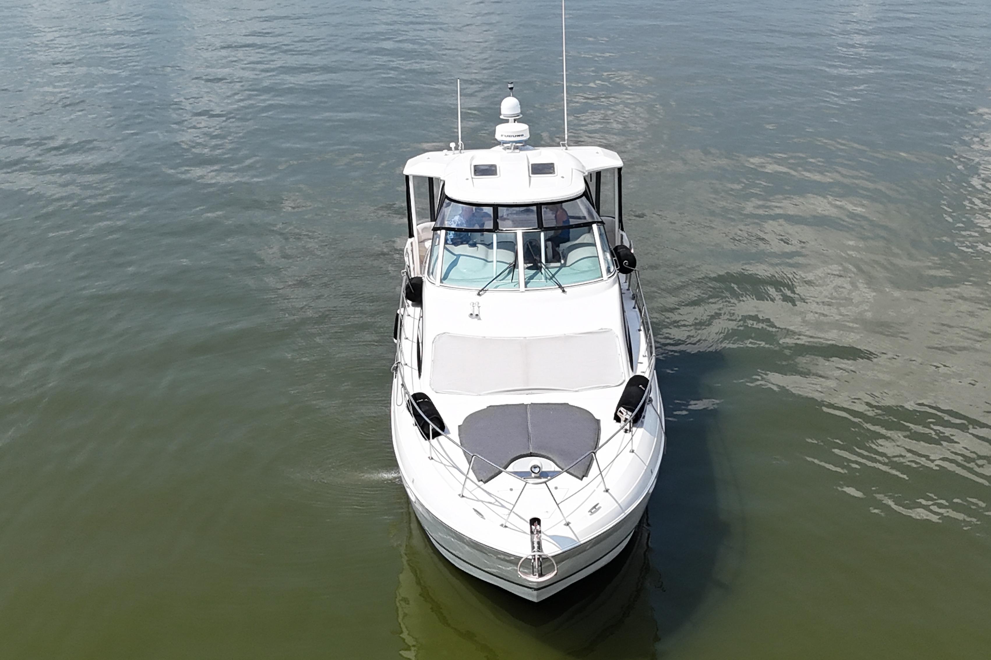 2004 Cruisers Yachts 405 Express Motoryacht on calm water, aerial view.