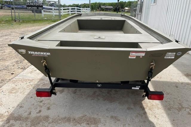 2026 Tracker Grizzly 1754 Utility boat on trailer, parked outdoors near a fence.