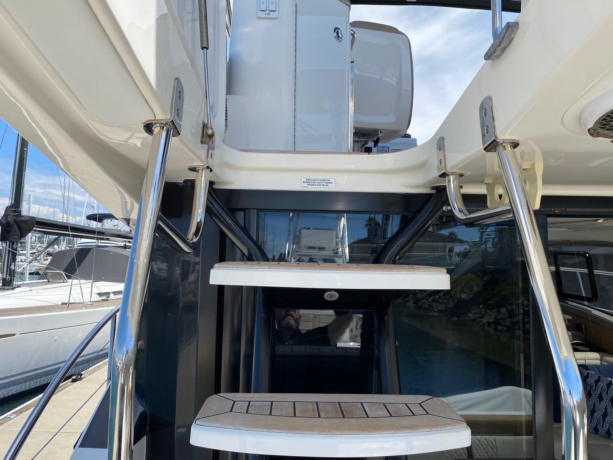 Stairs leading to the flybridge on a 2018 Sea Ray 400 Fly yacht.