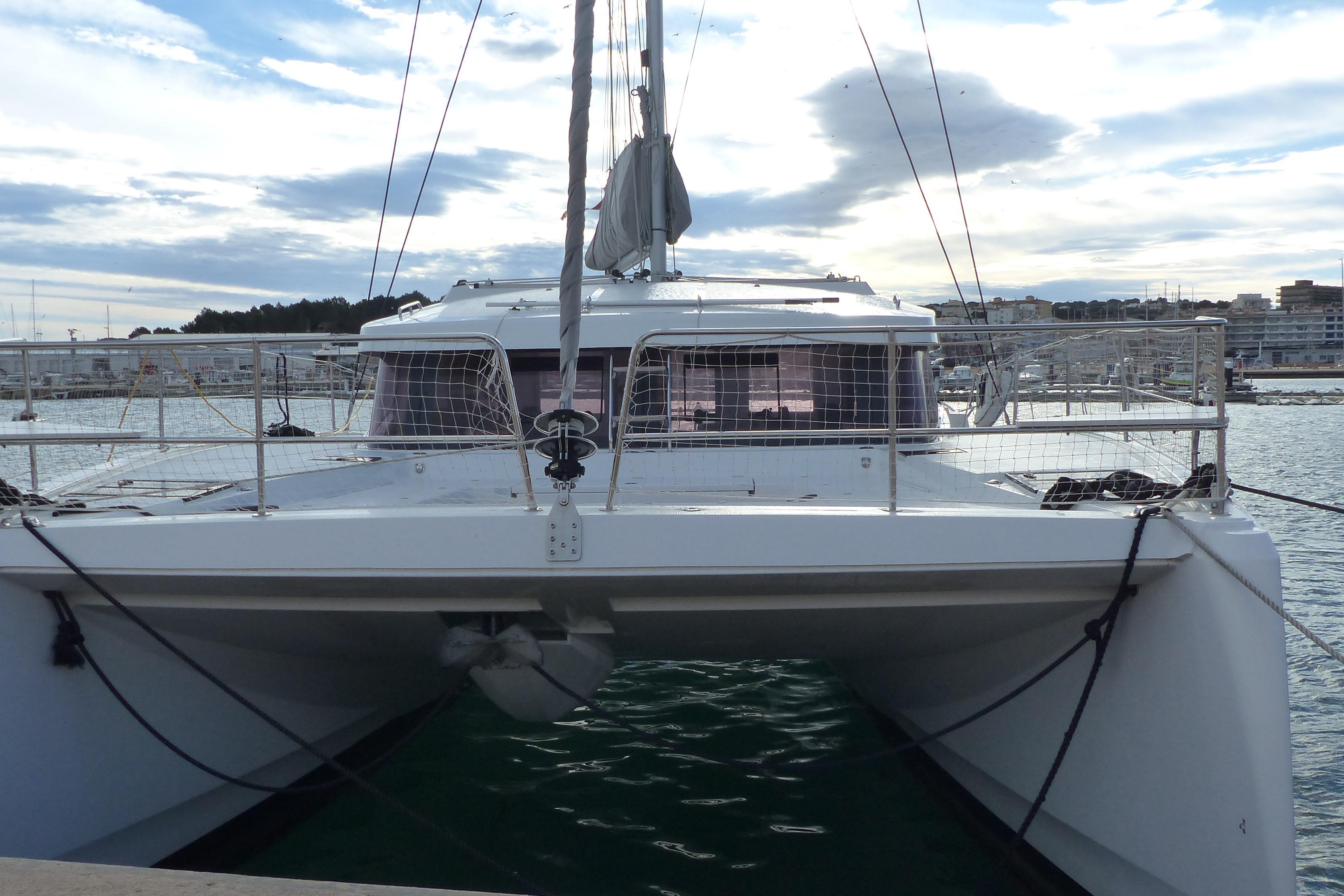 2024 Bali CATSMART catamaran docked at marina under cloudy sky.