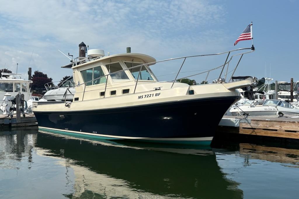 2003 Albin 28 Tournament Express boat docked with American flag.