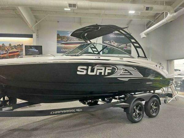2022 Chaparral 23 Surf boat displayed indoors on a trailer.