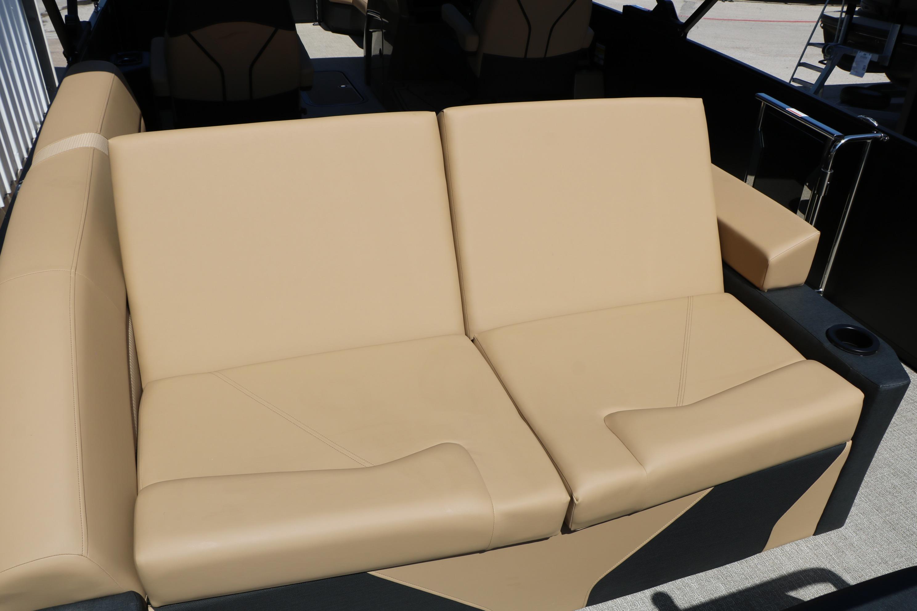 Luxurious beige seating on 2026 Evotti 725 CS Tri-Toon boat, featuring cup holders.