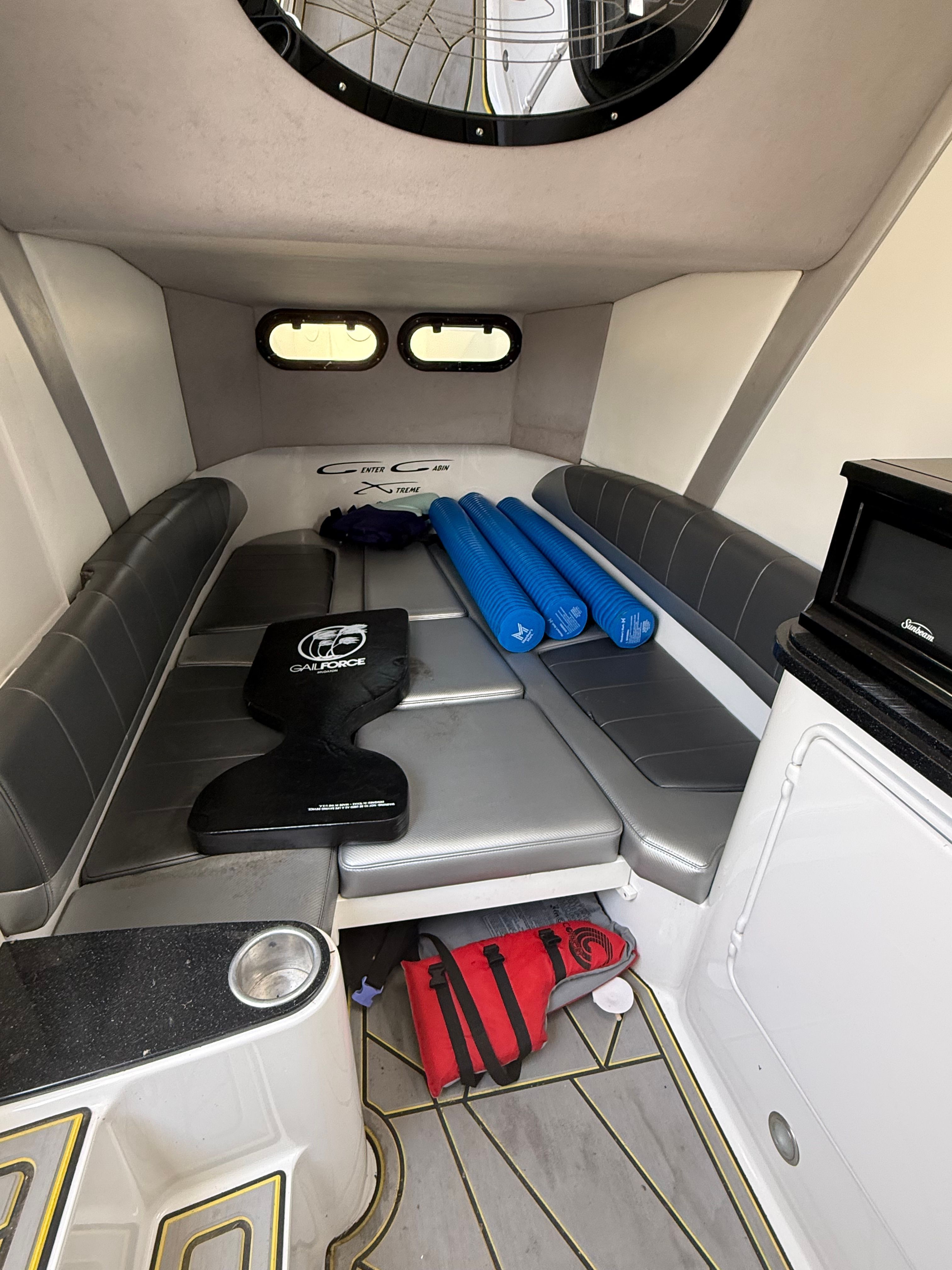 Interior of a 2014 Sunsation 34 CCX with gray seating and blue mats.