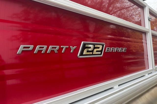2026 Sun Tracker Party Barge 22 DLX, red exterior with logo detail.