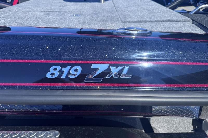 Close-up of 2026 Phoenix 819 ZXL boat model emblem with metallic finish.