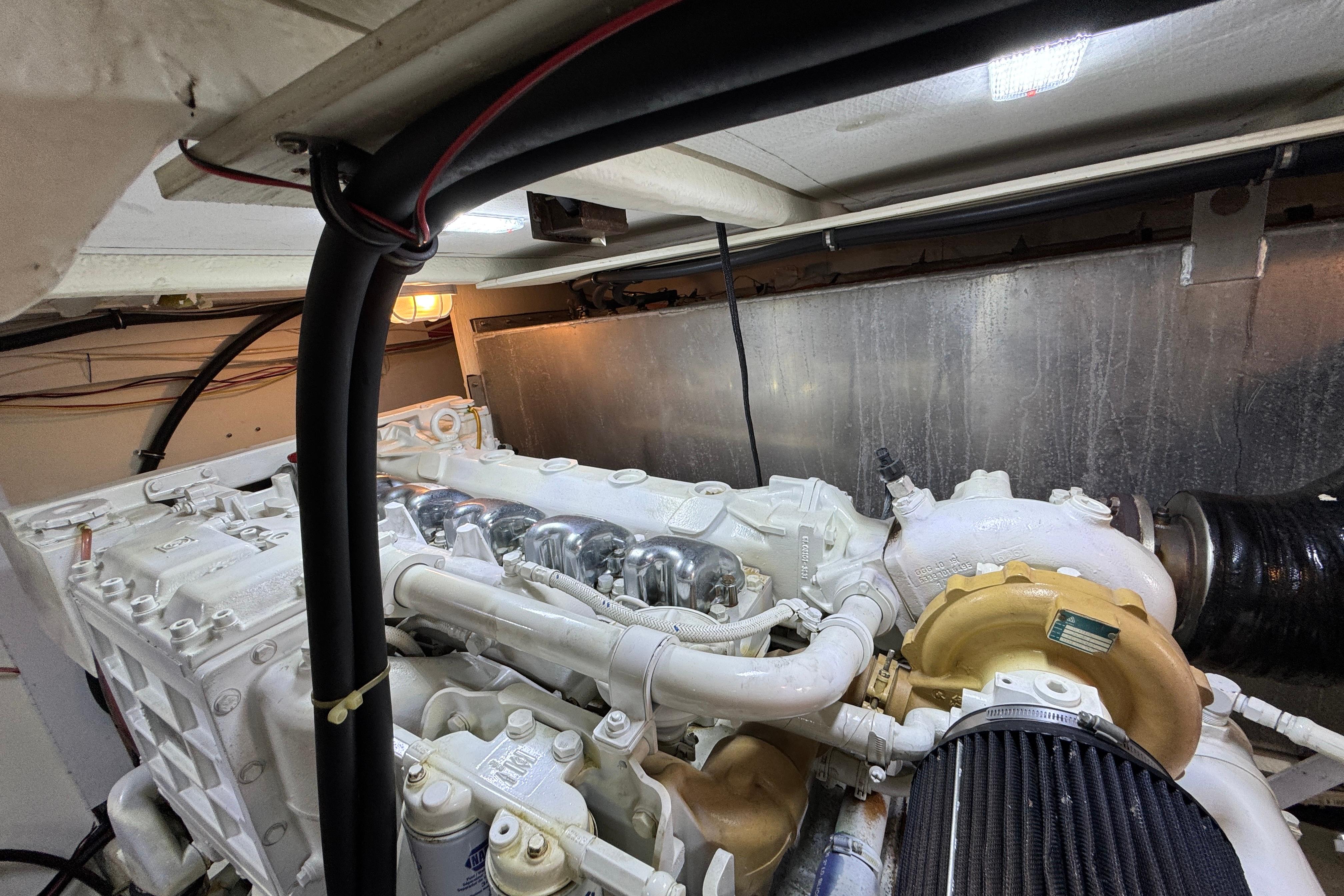 Engine room of 1998 Bayliner 5788 Pilot House Motoryacht, showcasing detailed machinery.