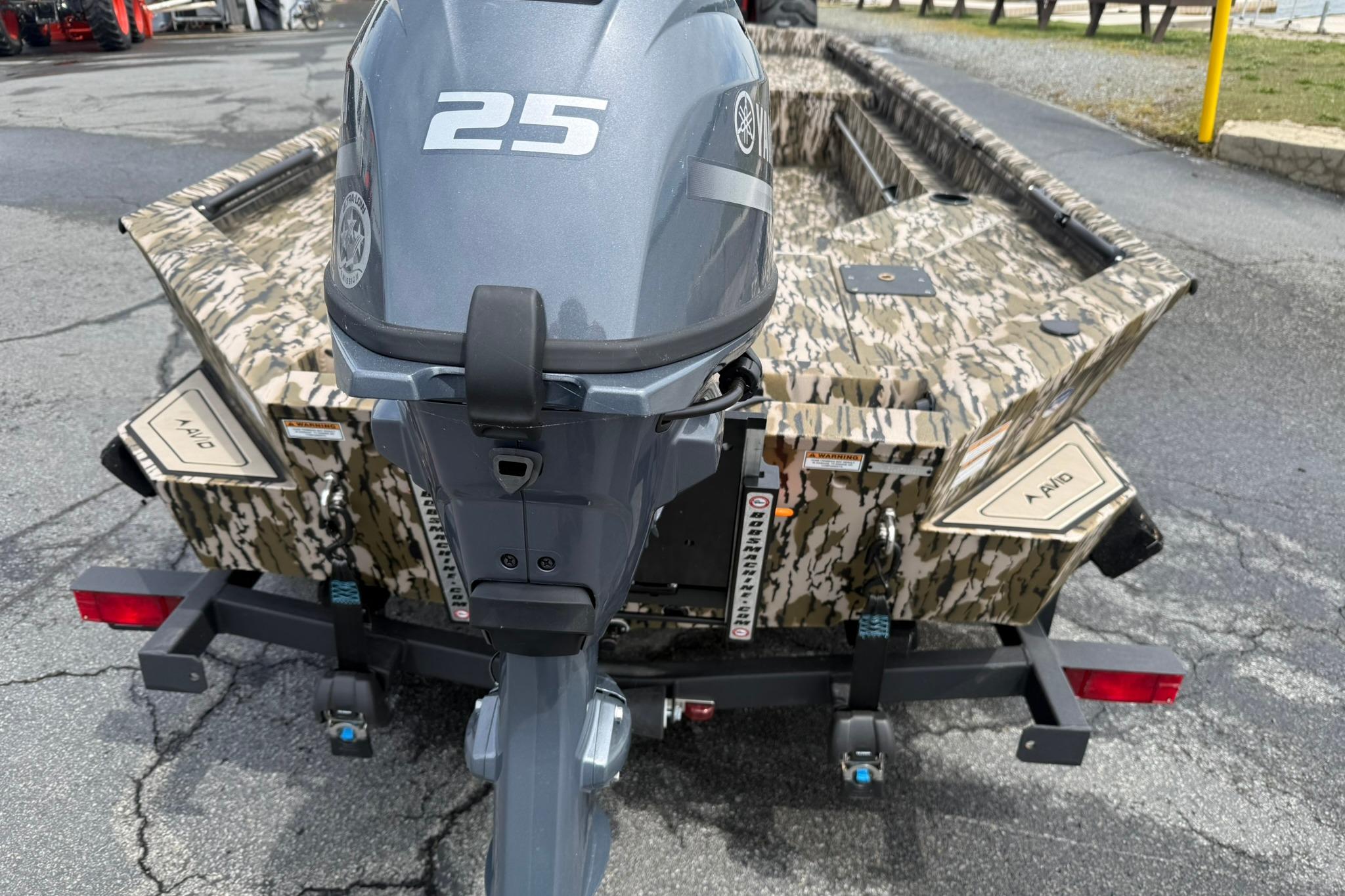 2026 Avid 16 Commander boat with camouflage design and Yamaha 25 outboard motor.