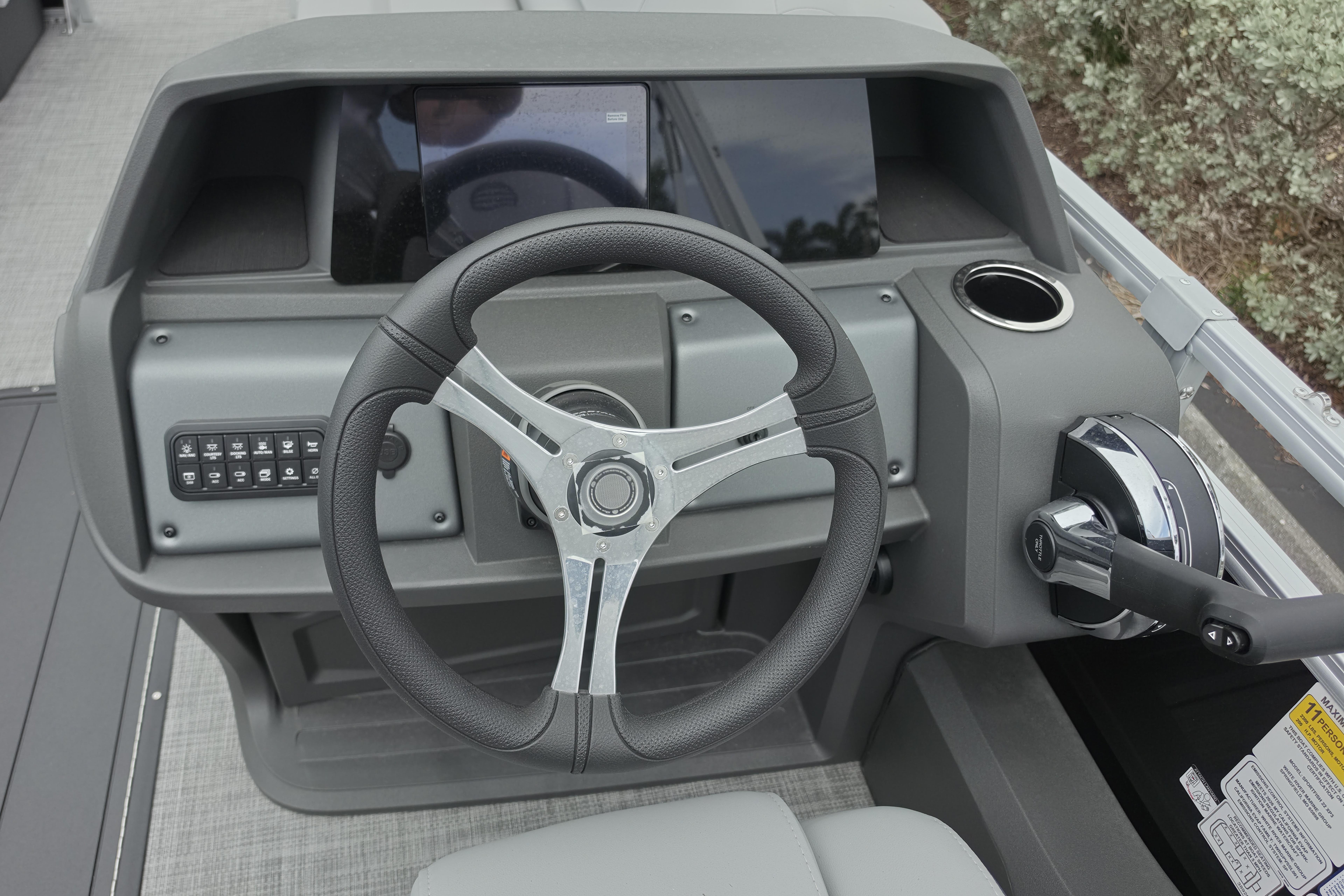 Steering console of 2026 Sun Tracker SportFish 22 XP3 boat with modern controls.