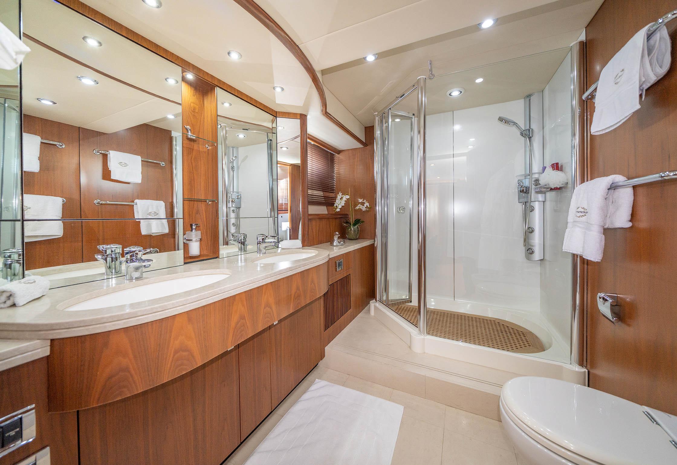 Luxurious bathroom on a 2006 Sunseeker 82 Yacht, featuring elegant wood finishes and modern amenities.