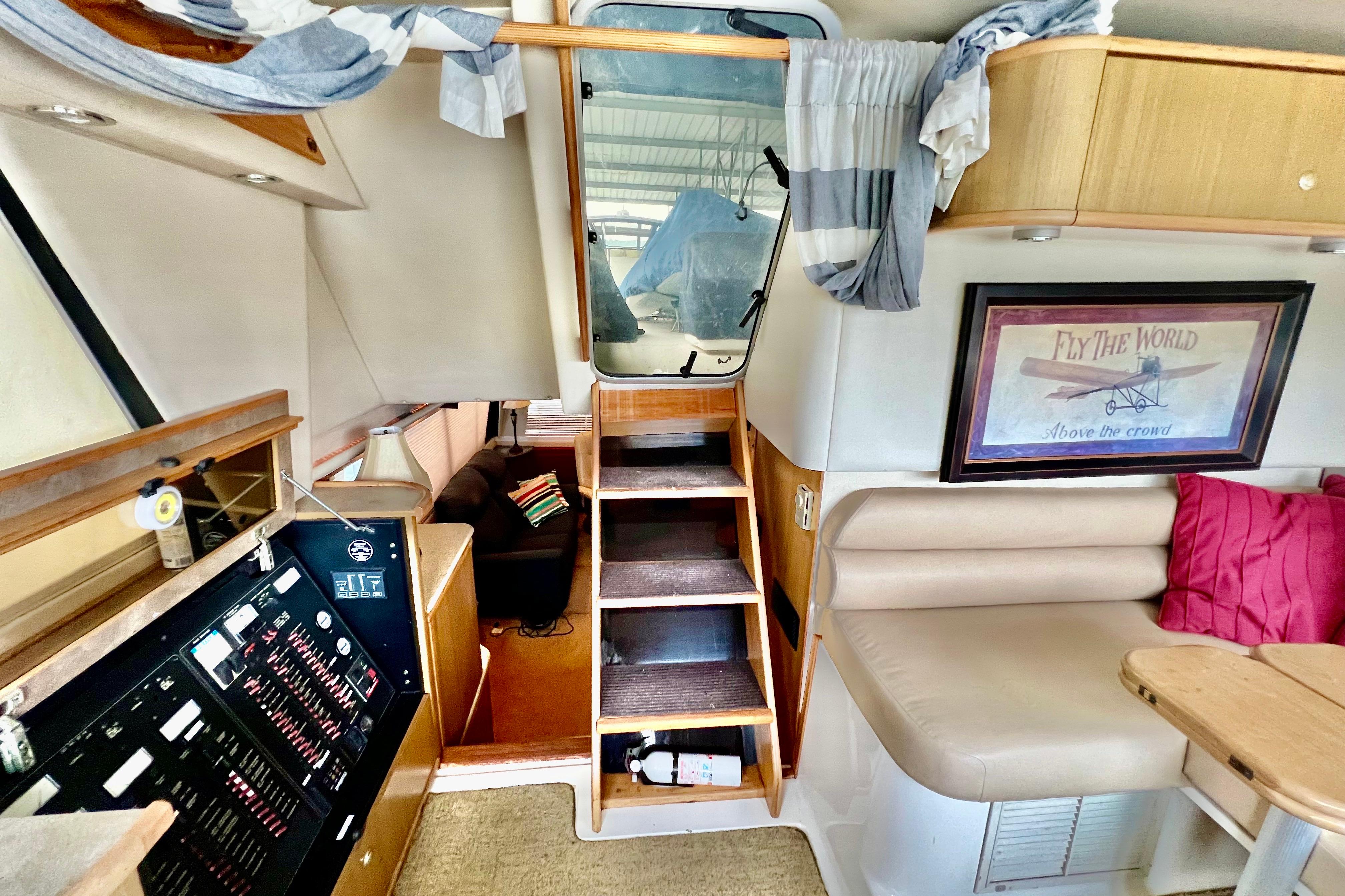 Interior of 2001 Bayliner 4788 Pilot House Motoryacht with cozy seating and nautical decor.