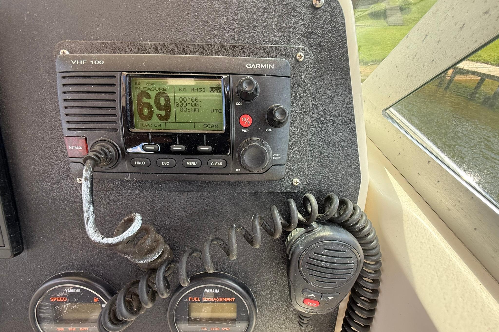 Garmin VHF 100 radio on 2003 Pursuit 2870 Walkaround boat dashboard.