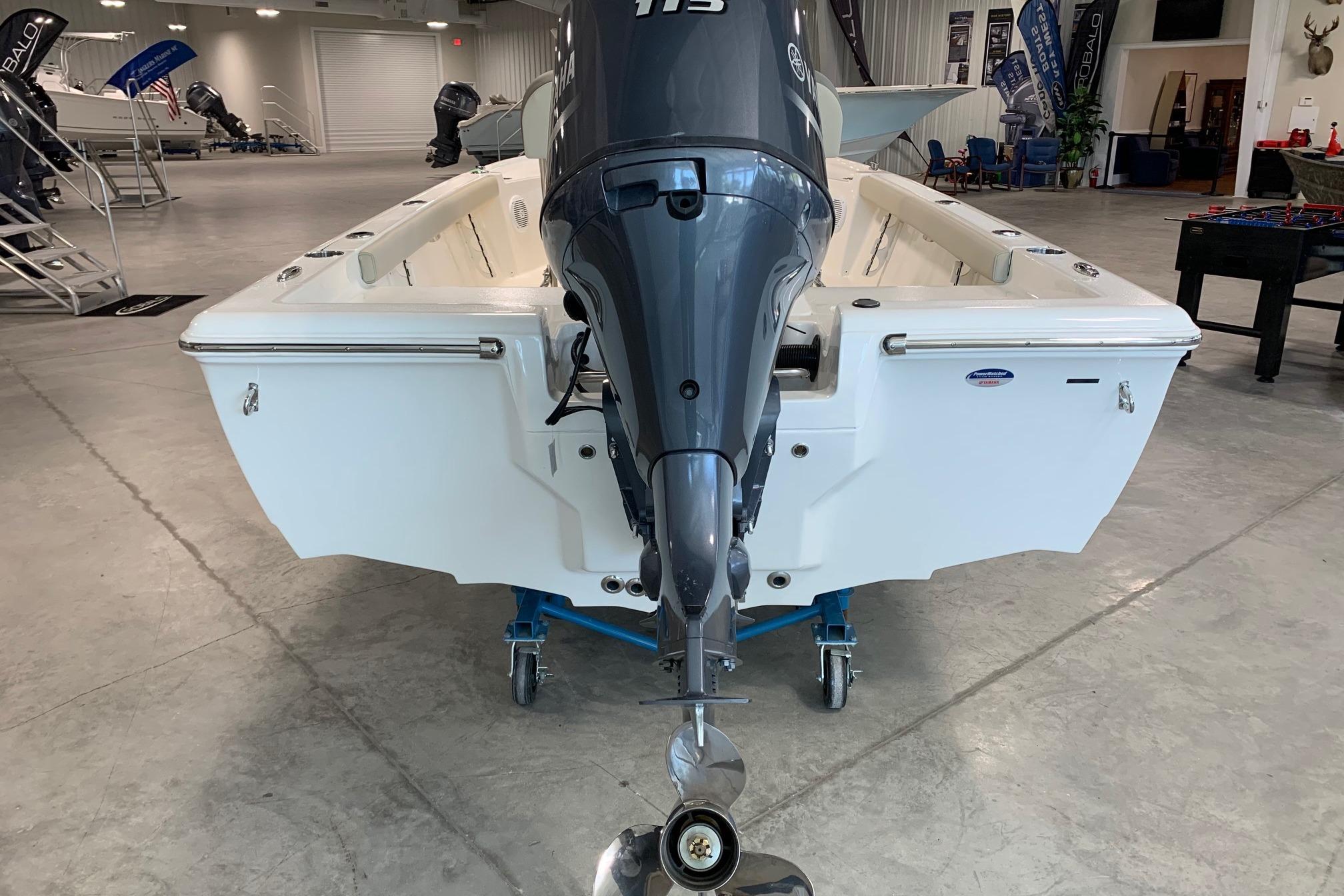 2026 Key West 188 Bay Reef boat with outboard motor in showroom.