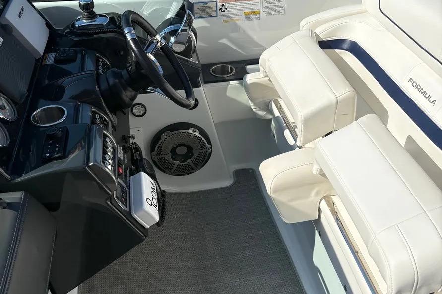 Interior of 2015 Formula 350 Crossover Bowrider, featuring steering wheel and white seating.