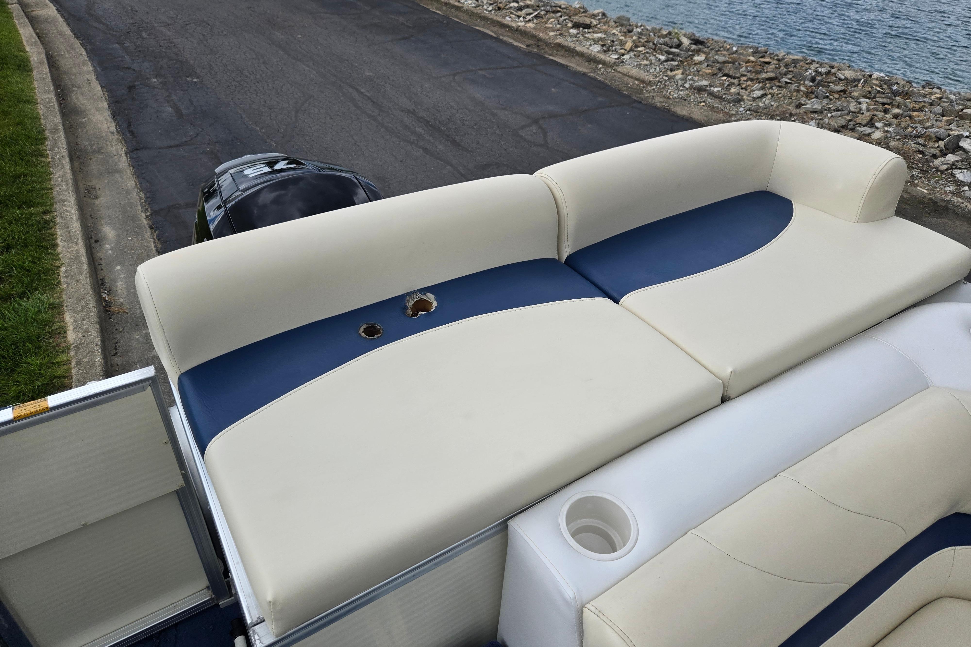 2004 Odyssey Pontoons 2302 Millennium boat seating with blue and white upholstery, near water.