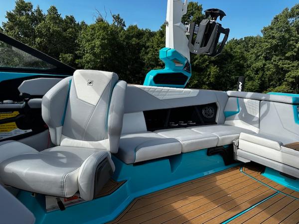 2022 Nautique S23 boat interior with gray seating and blue accents.