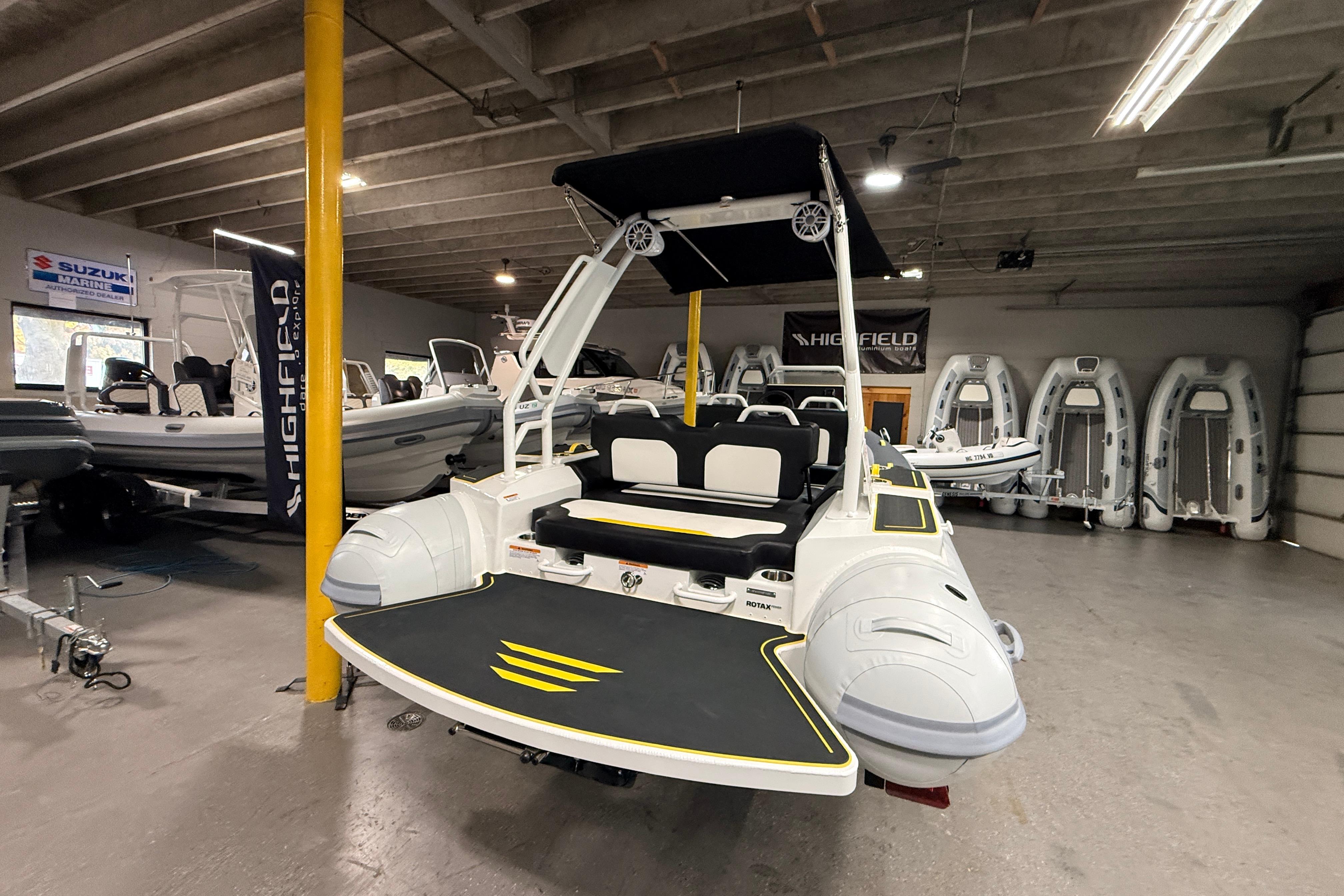 2026 Highfield VELOX 560 boat displayed in a showroom with other inflatable boats.