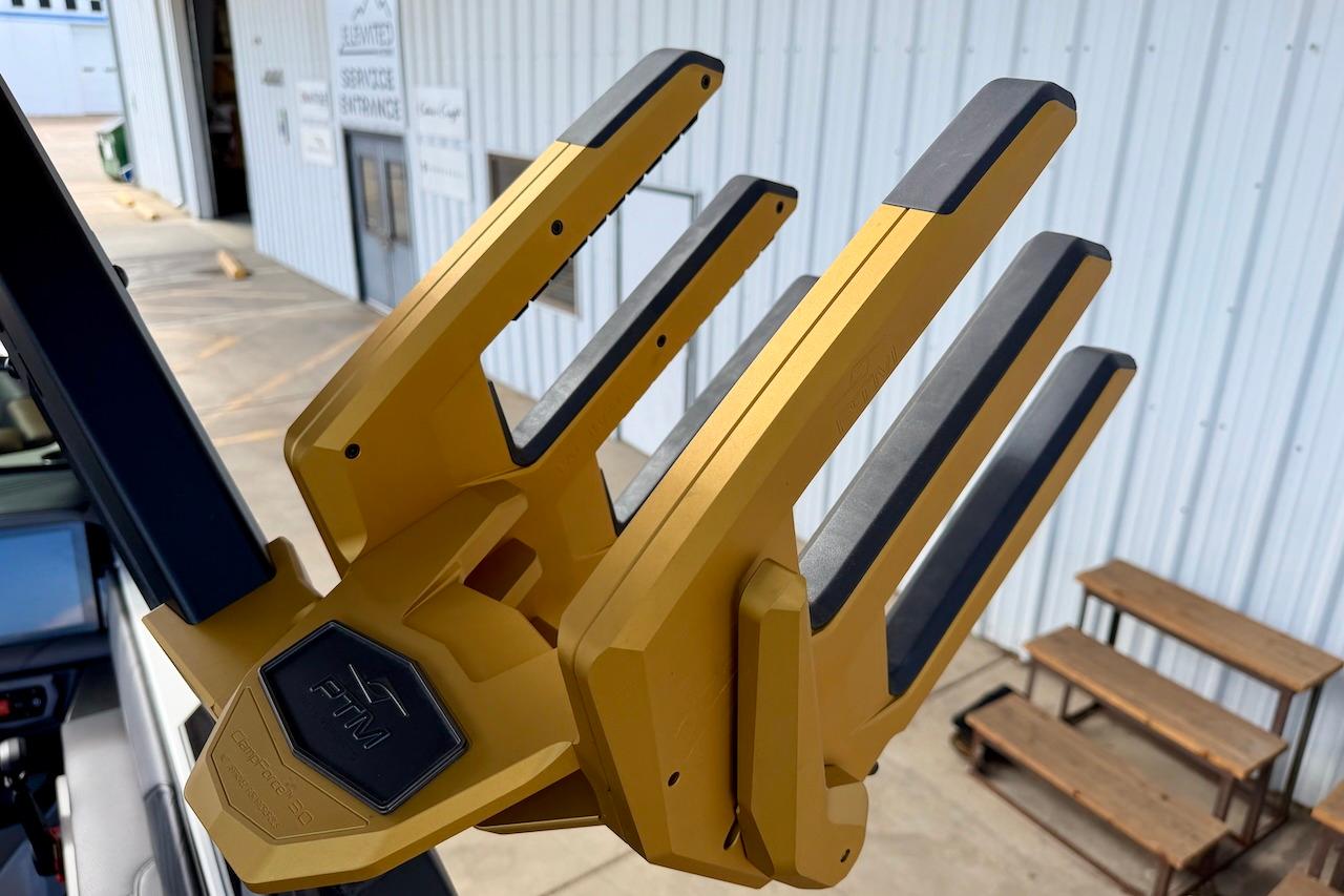 Gold wakeboard rack on 2025 Tigé Ultré 25ZX boat, near service entrance.