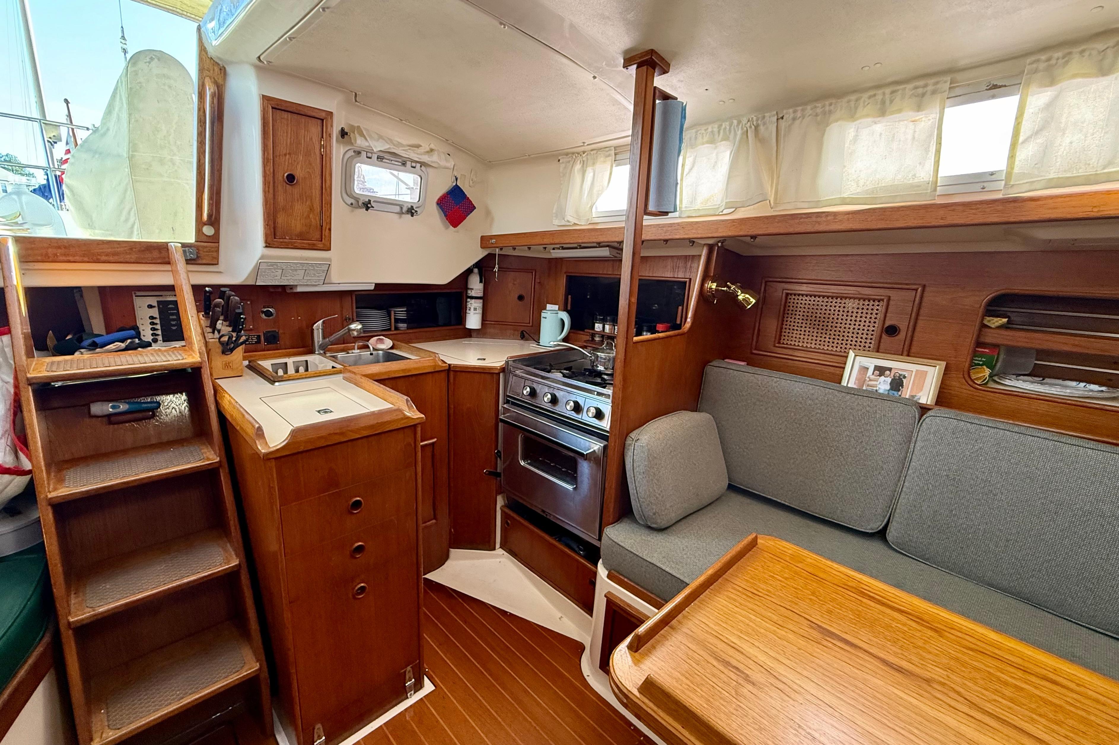Interior of 1985 Niagara Encore sailboat with kitchen and seating area.
