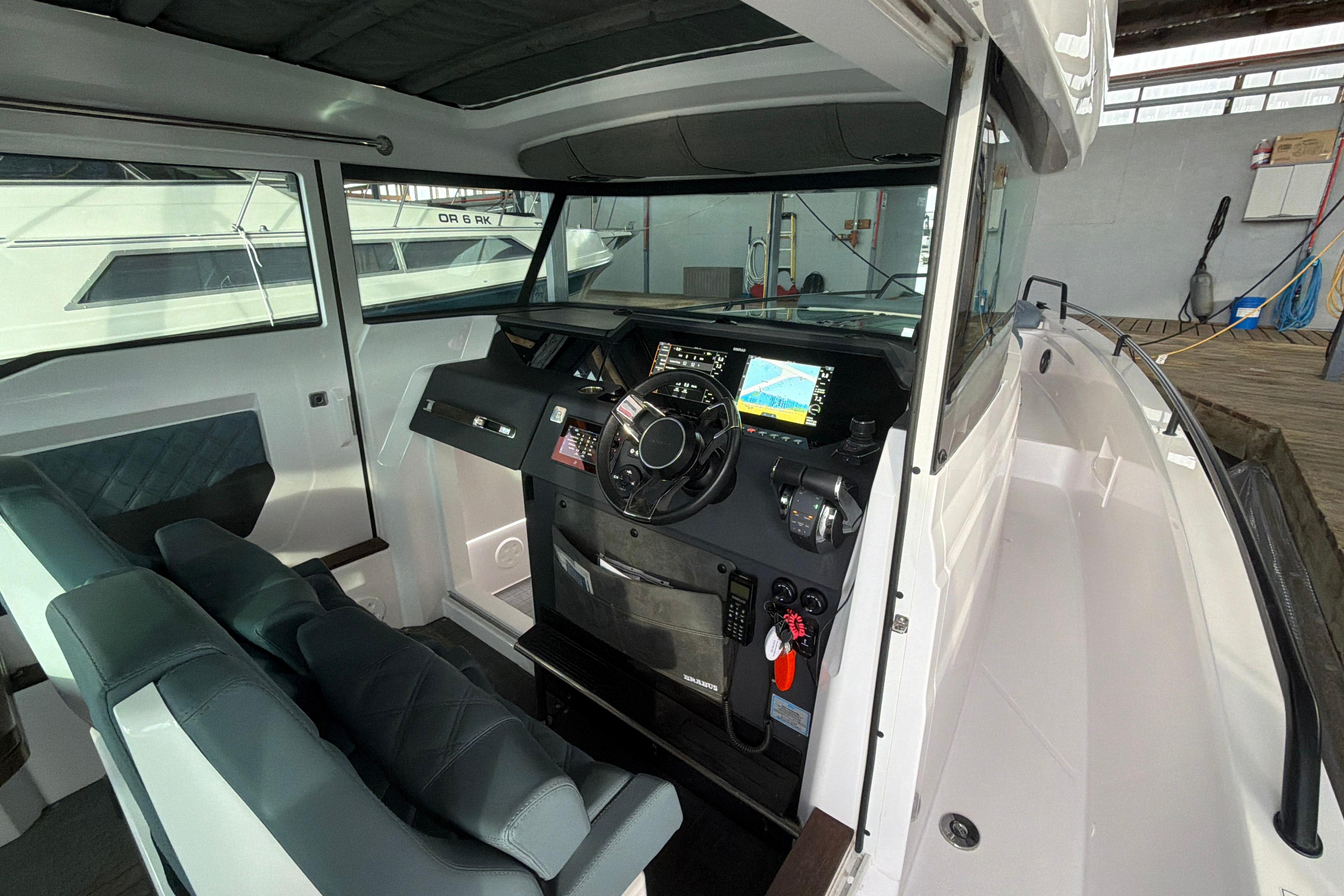 Interior of 2022 Axopar Brabus 37 XC Cross Cabin, featuring modern dashboard and seating.