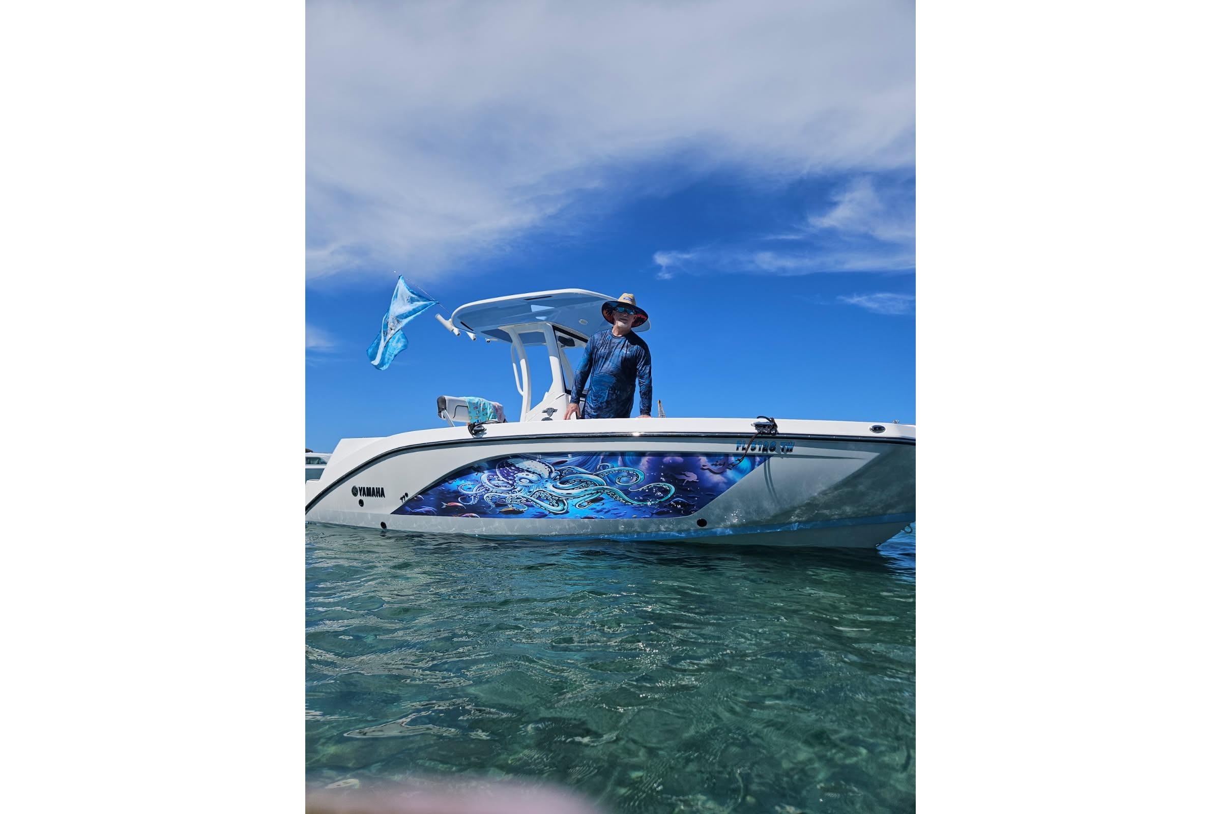 2024 Yamaha Boats 222 FSH Sport E on clear water, featuring vibrant side graphics.