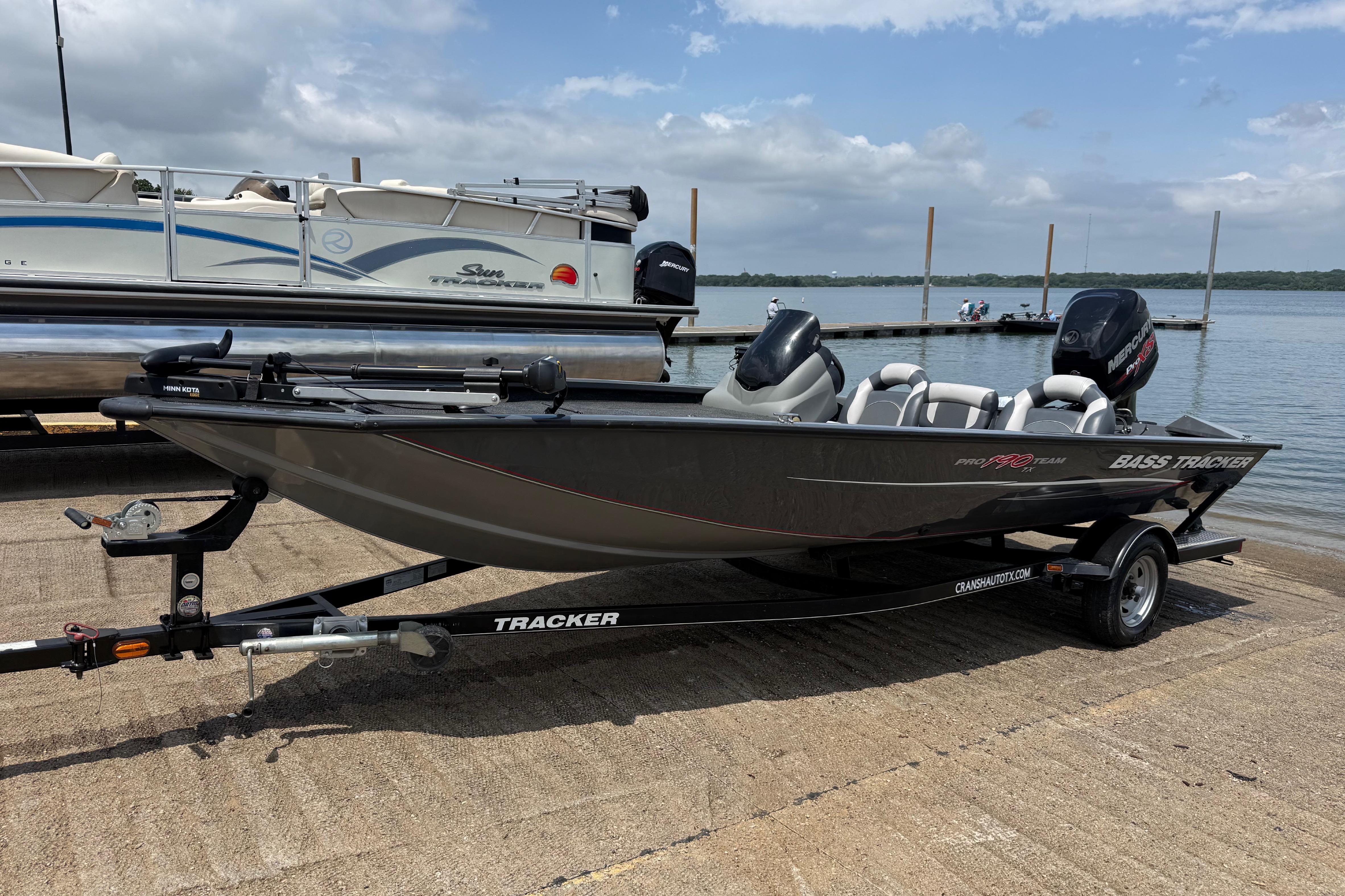 2015 Tracker Pro Team 190 TX boat on trailer by a lake dock.