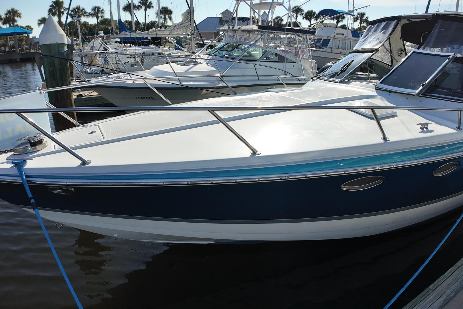 2007 Formula 330 Sun Sport boat docked at marina, surrounded by other vessels.