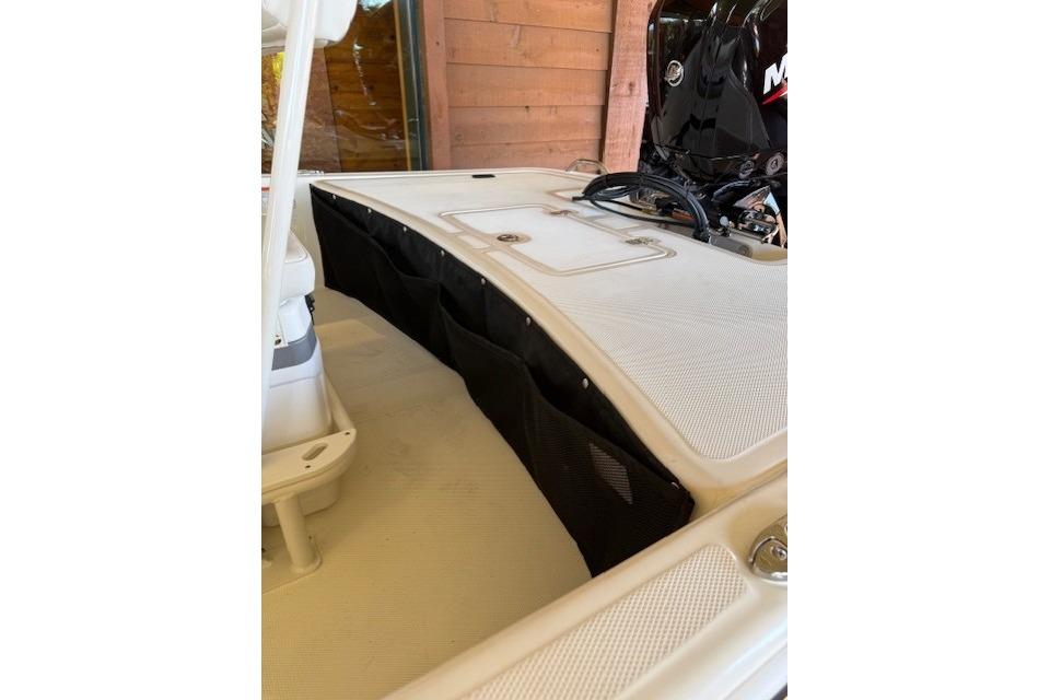2026 Mako Pro Skiff 17 CC boat interior with storage compartments and motor.