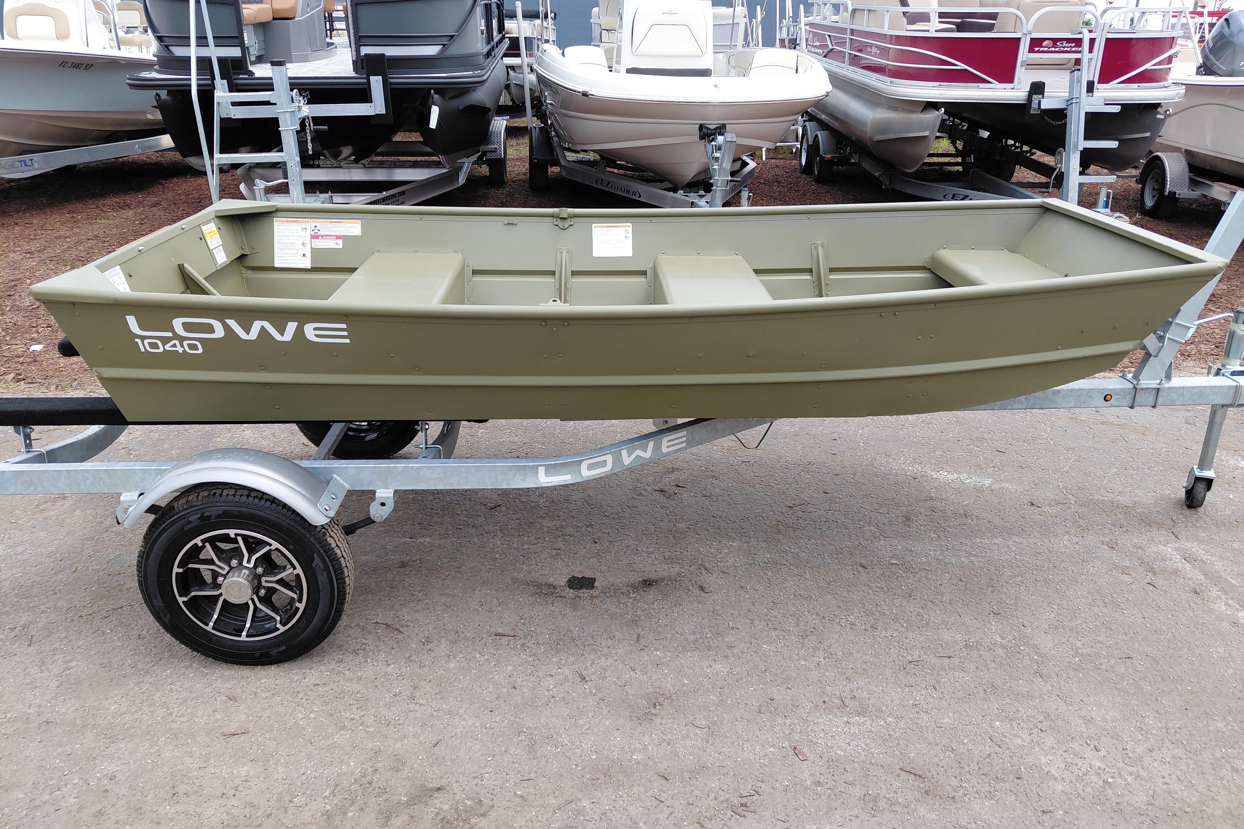 2025 Lowe L1040 Jon boat on trailer, displayed outdoors among other boats.