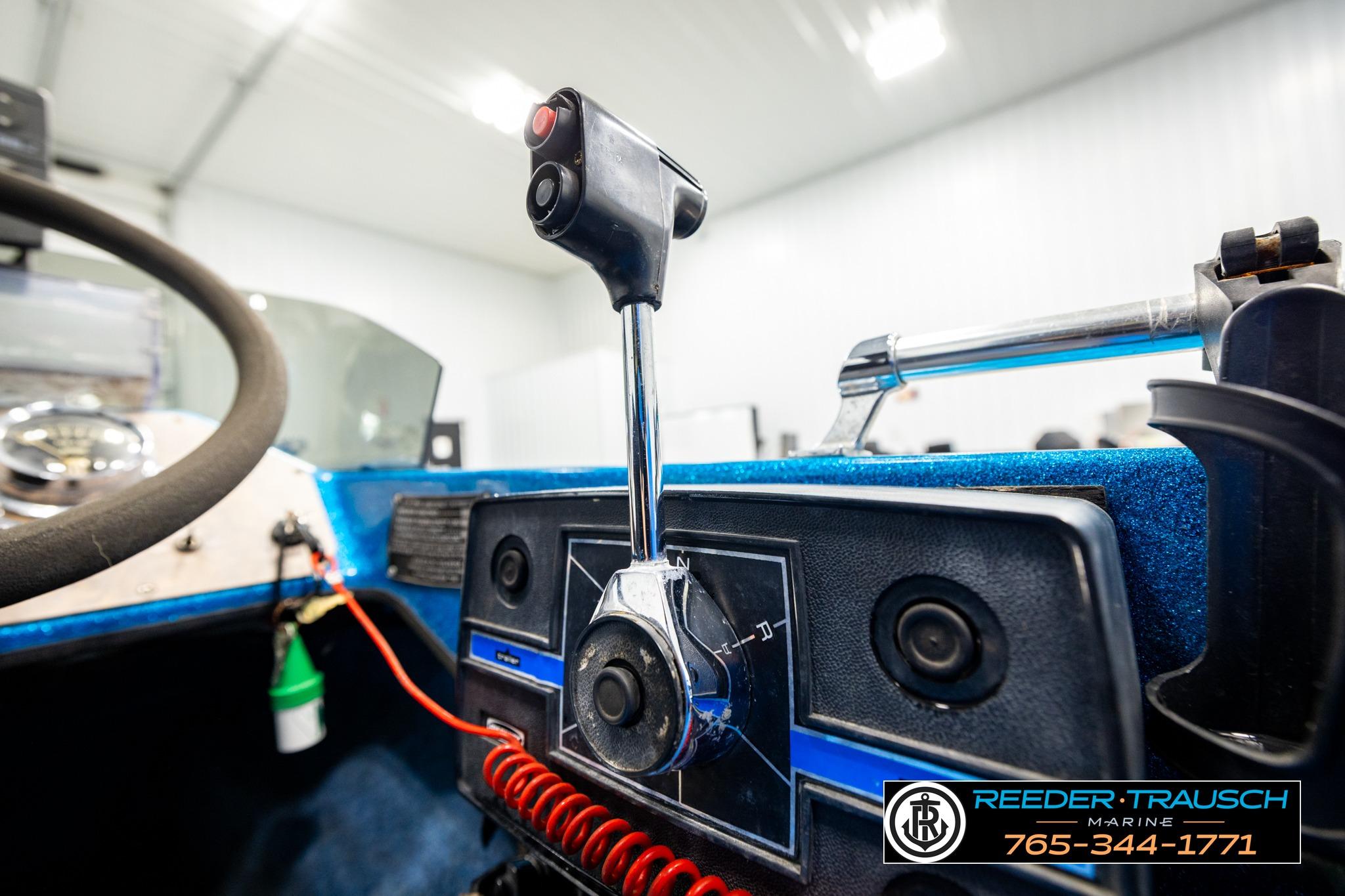 1980 Ranger 175 VS boat dashboard with steering wheel and control lever.