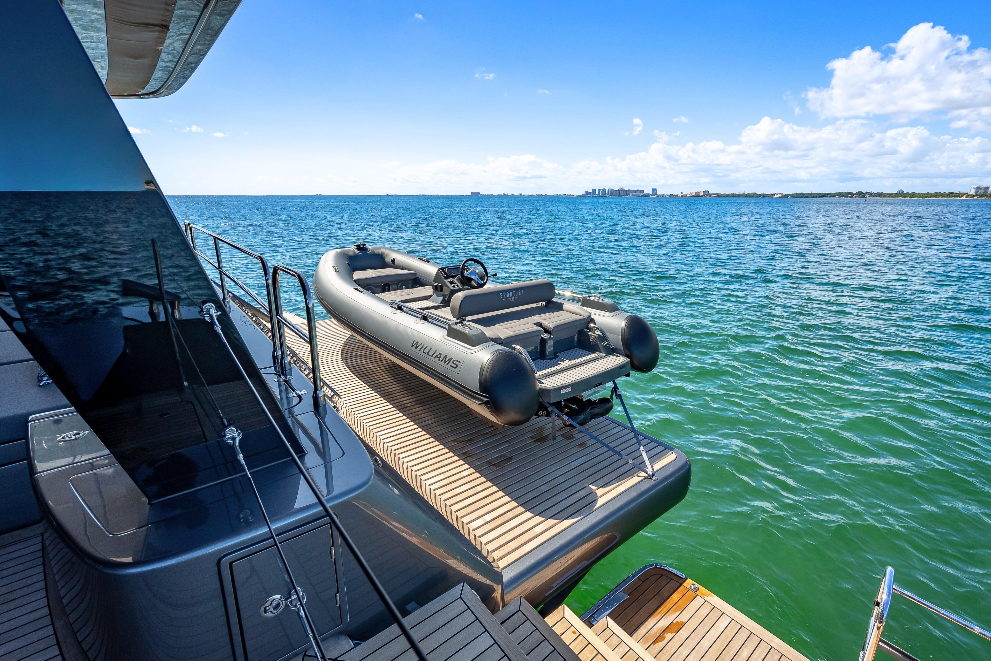 2026 Sunreef 60 Power yacht with tender on deck, overlooking serene ocean view.