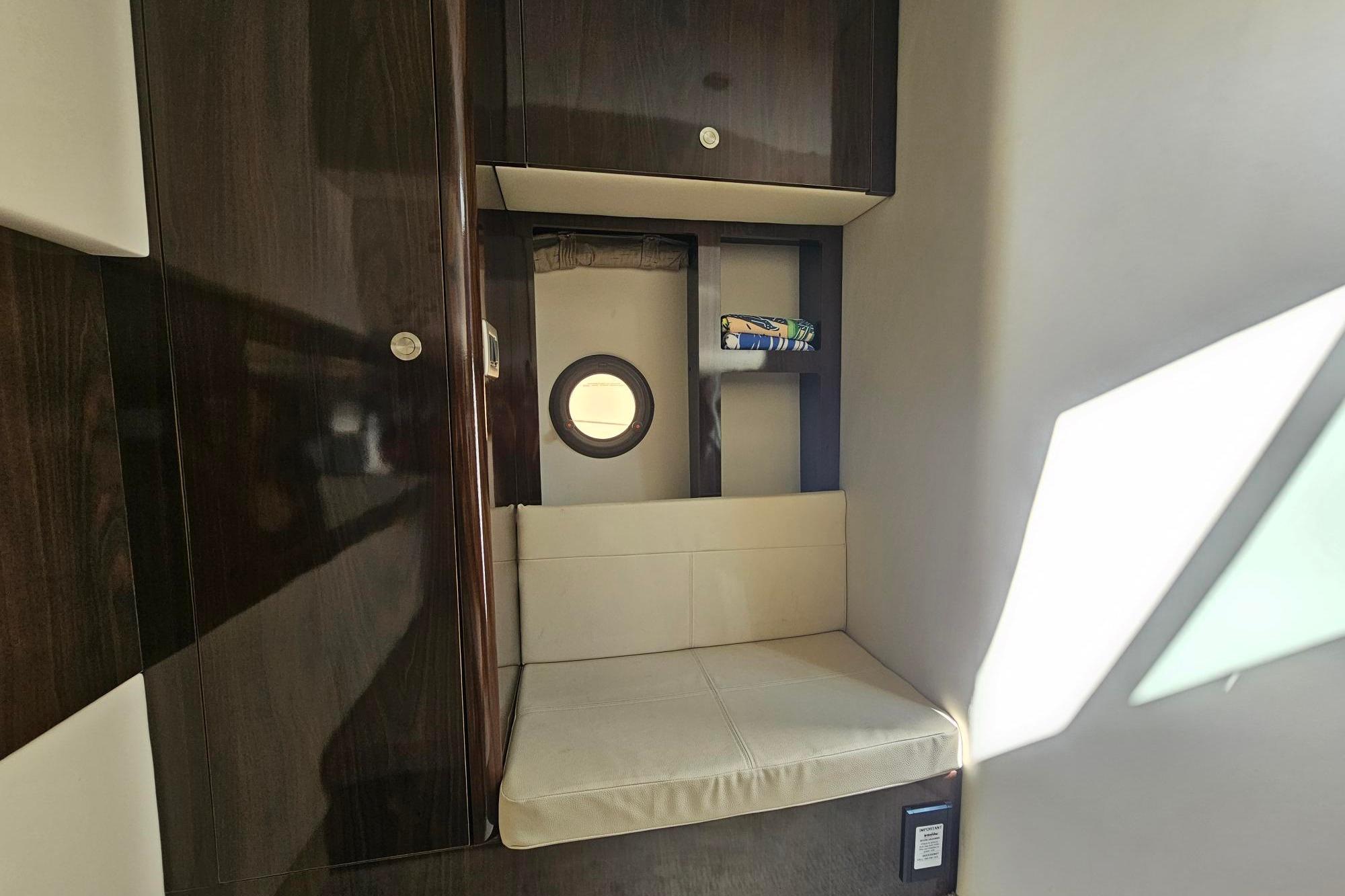 2016 Sea Ray Sundancer 350 cabin interior with seating and storage.