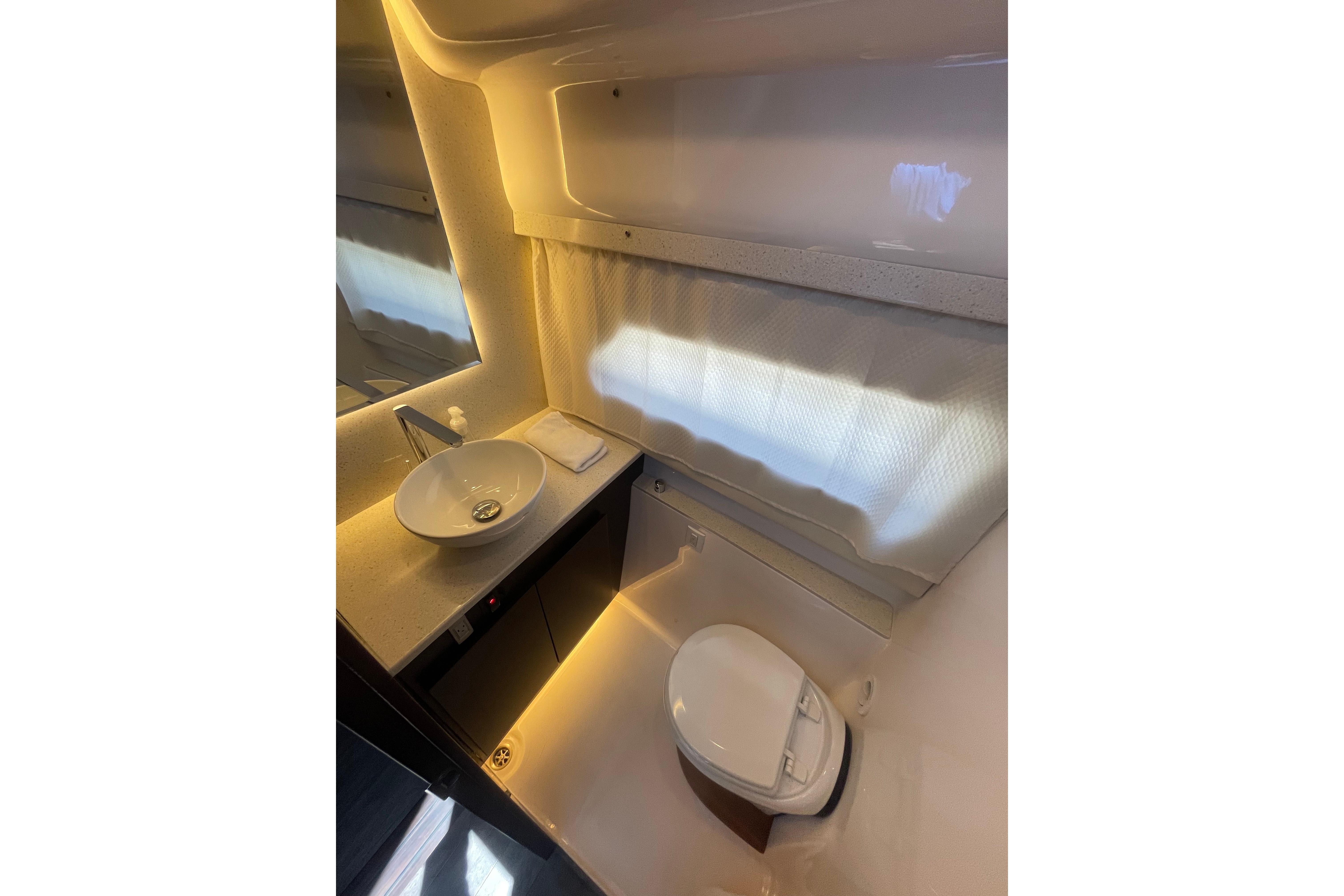 Luxurious bathroom interior of 2020 Regal 42 Grande Coupe yacht, featuring modern sink and toilet.