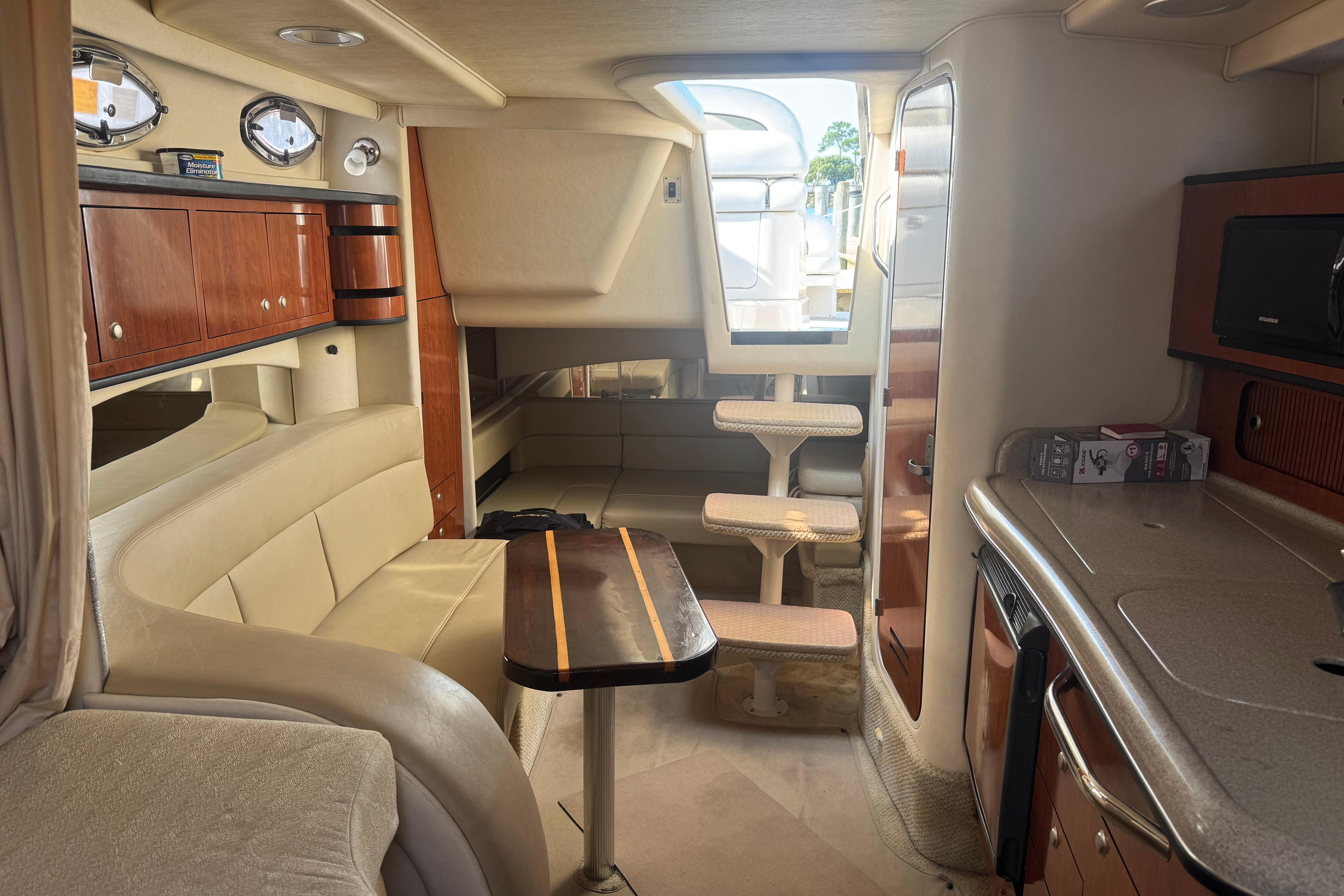 Interior of a 2006 Sea Ray 300 Sundancer yacht with seating and kitchenette.