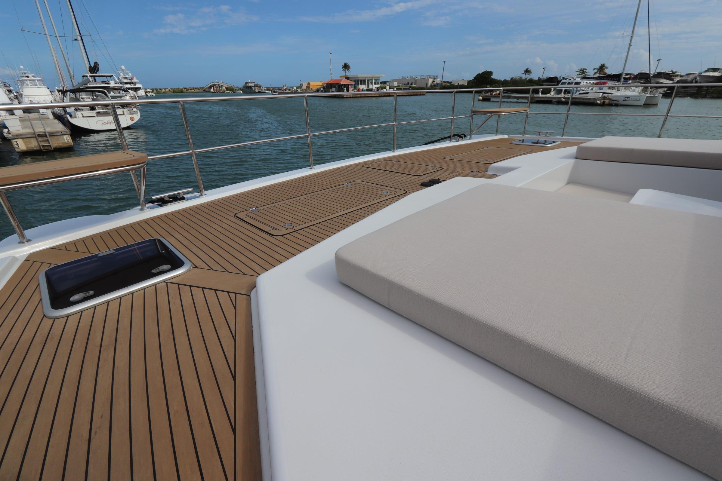 Luxurious deck of 2025 Two Oceans 55 yacht with elegant seating and scenic marina view.