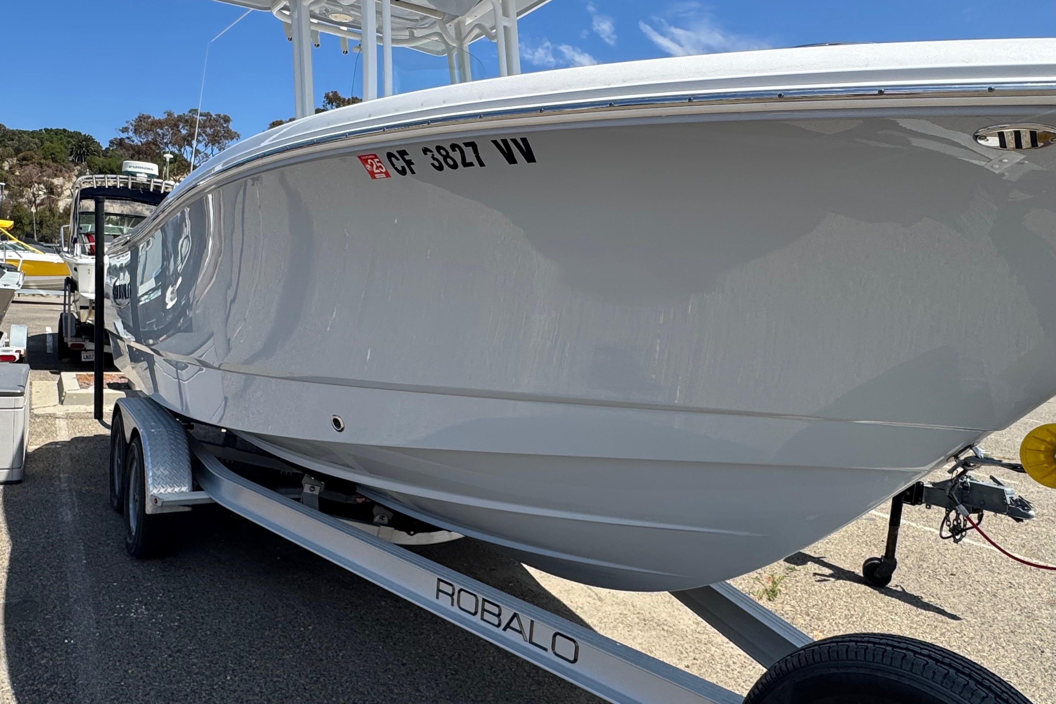 2022 Robalo R230 Center Console boat on trailer, parked outdoors.