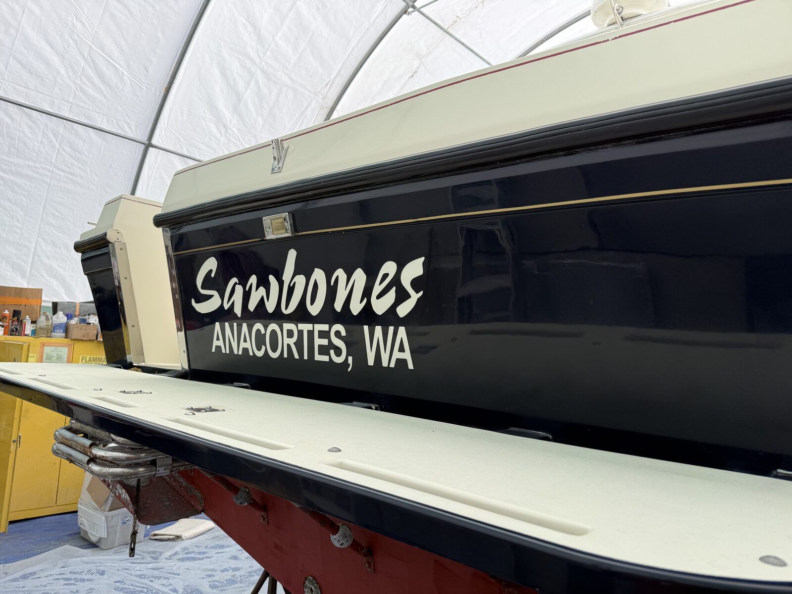 The boat "Sawbones" from Anacortes, WA, is in a covered area.