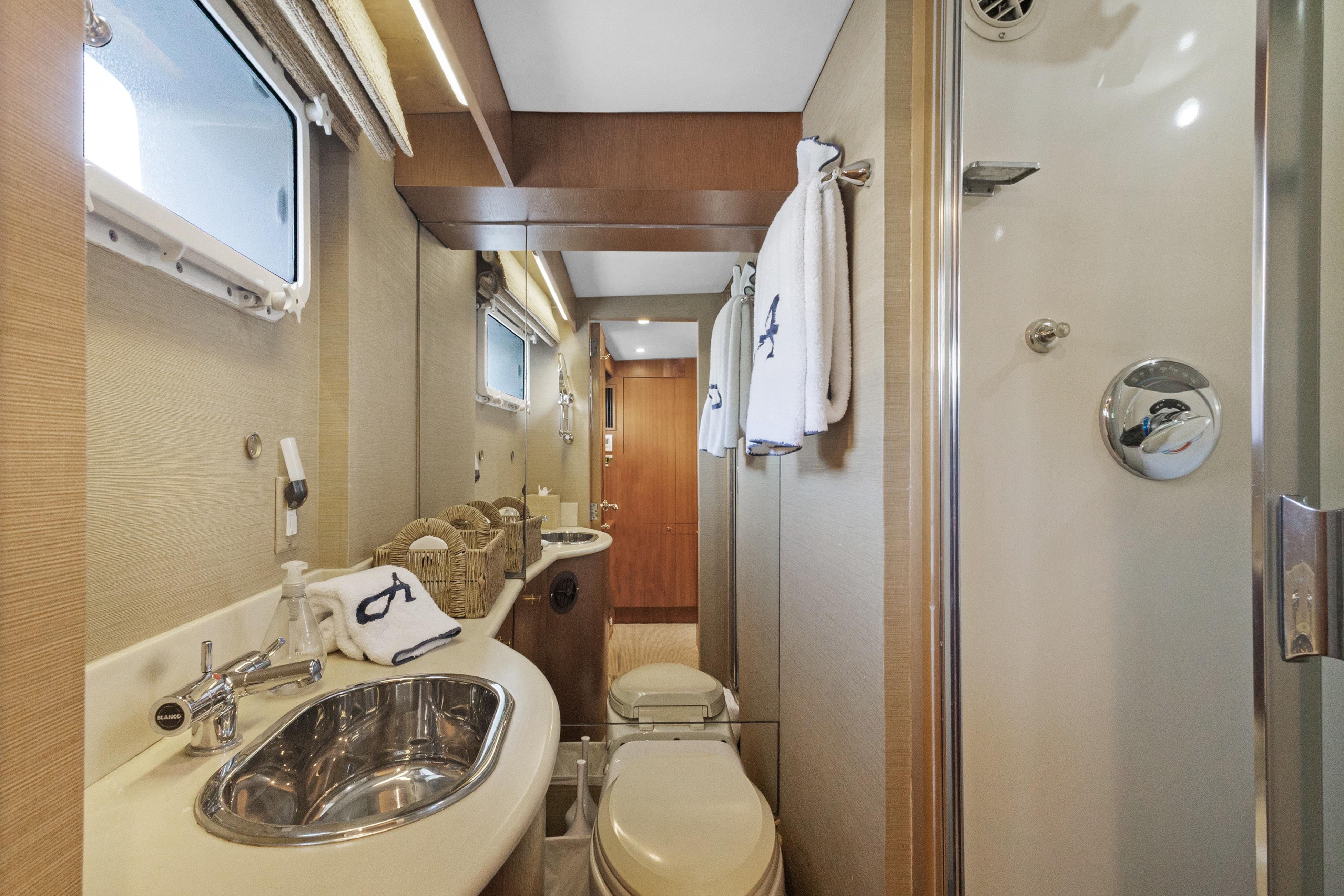 Luxurious yacht bathroom with modern fixtures, shower, and elegant decor, 1985 Burger model.