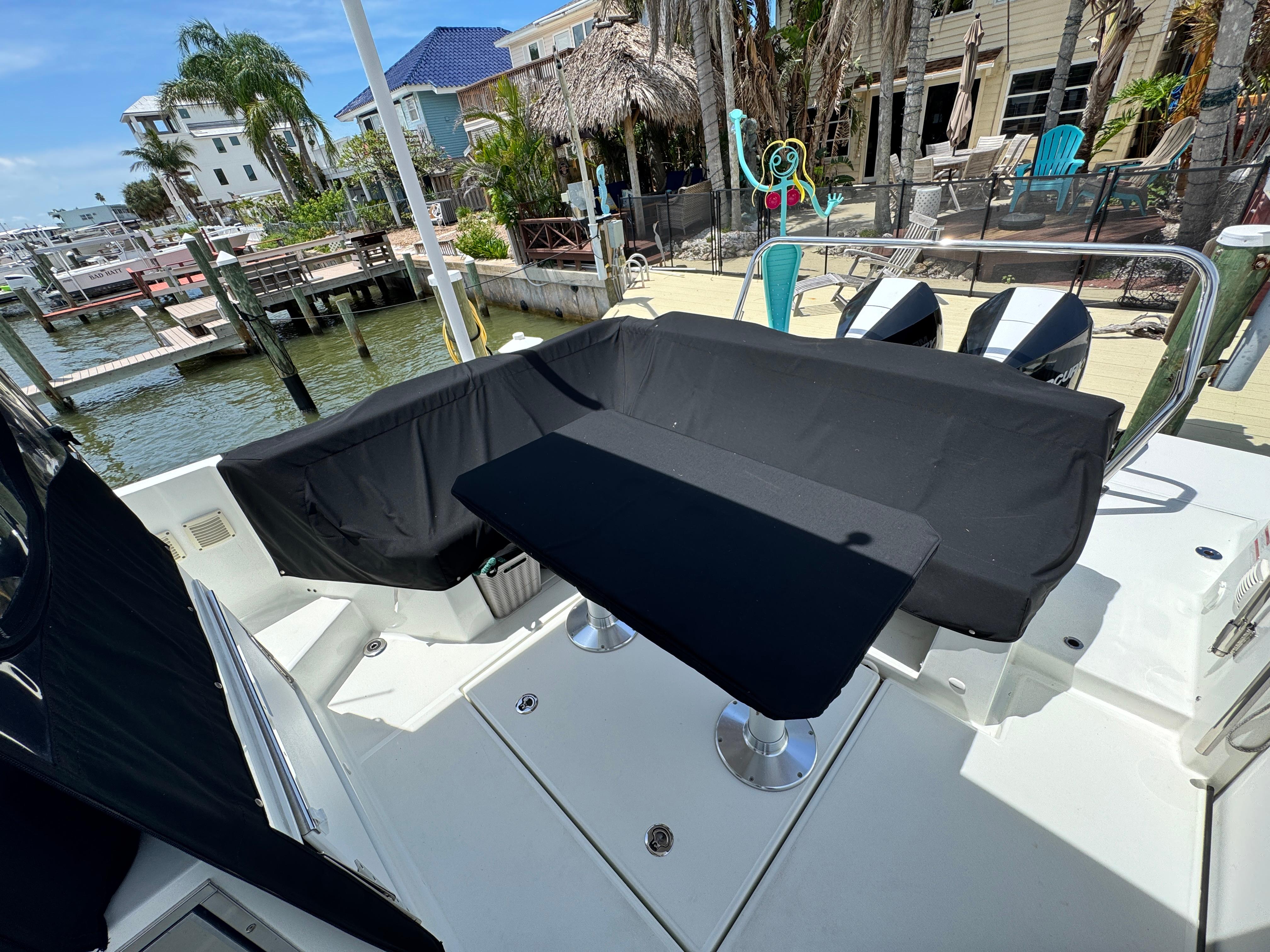 2022 Beneteau Flyer 9 SUNdeck boat with covered seating area at a dockside location.