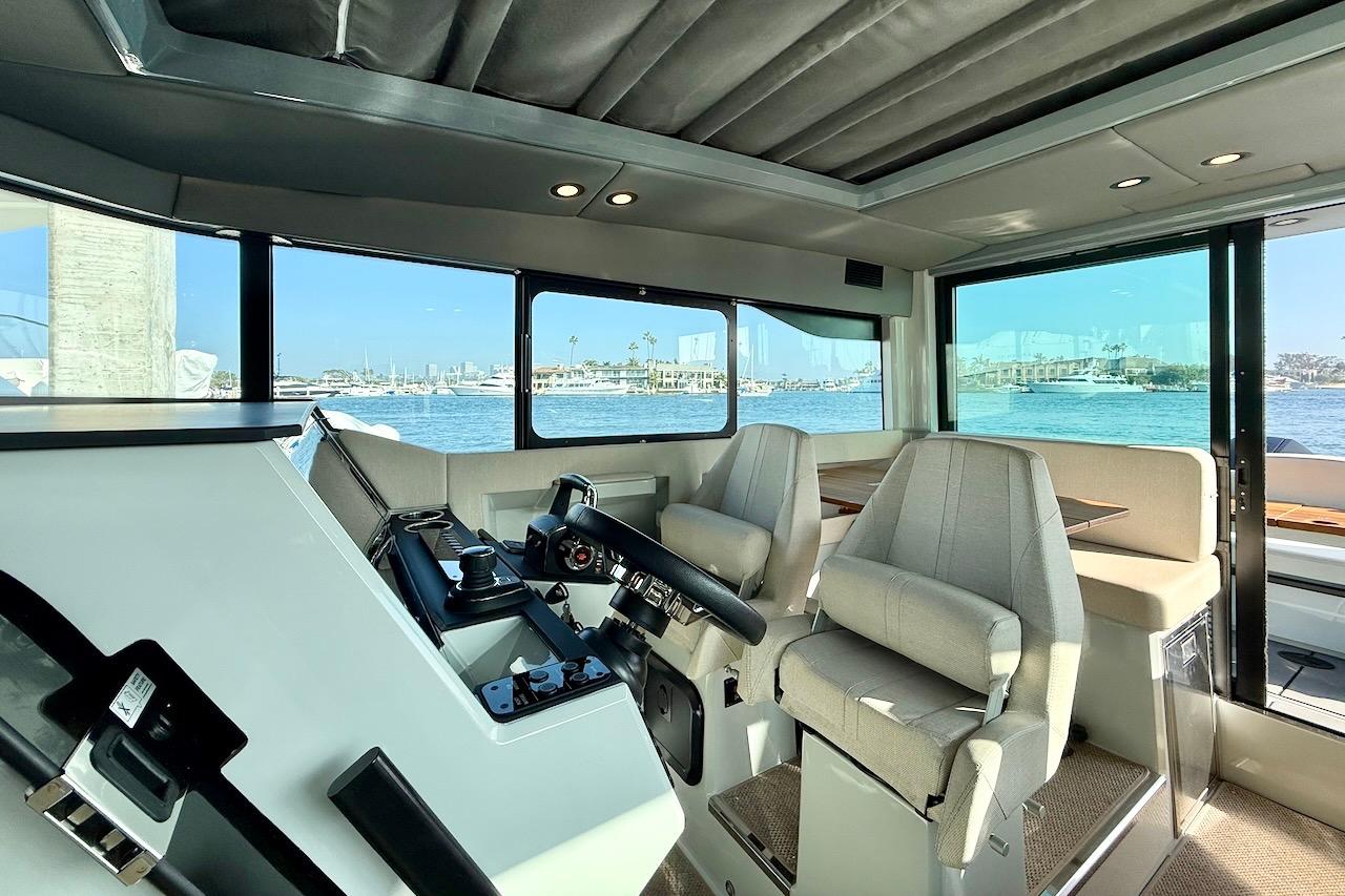 Interior of 2024 Saxdor 320 GTC boat with modern helm and seating.