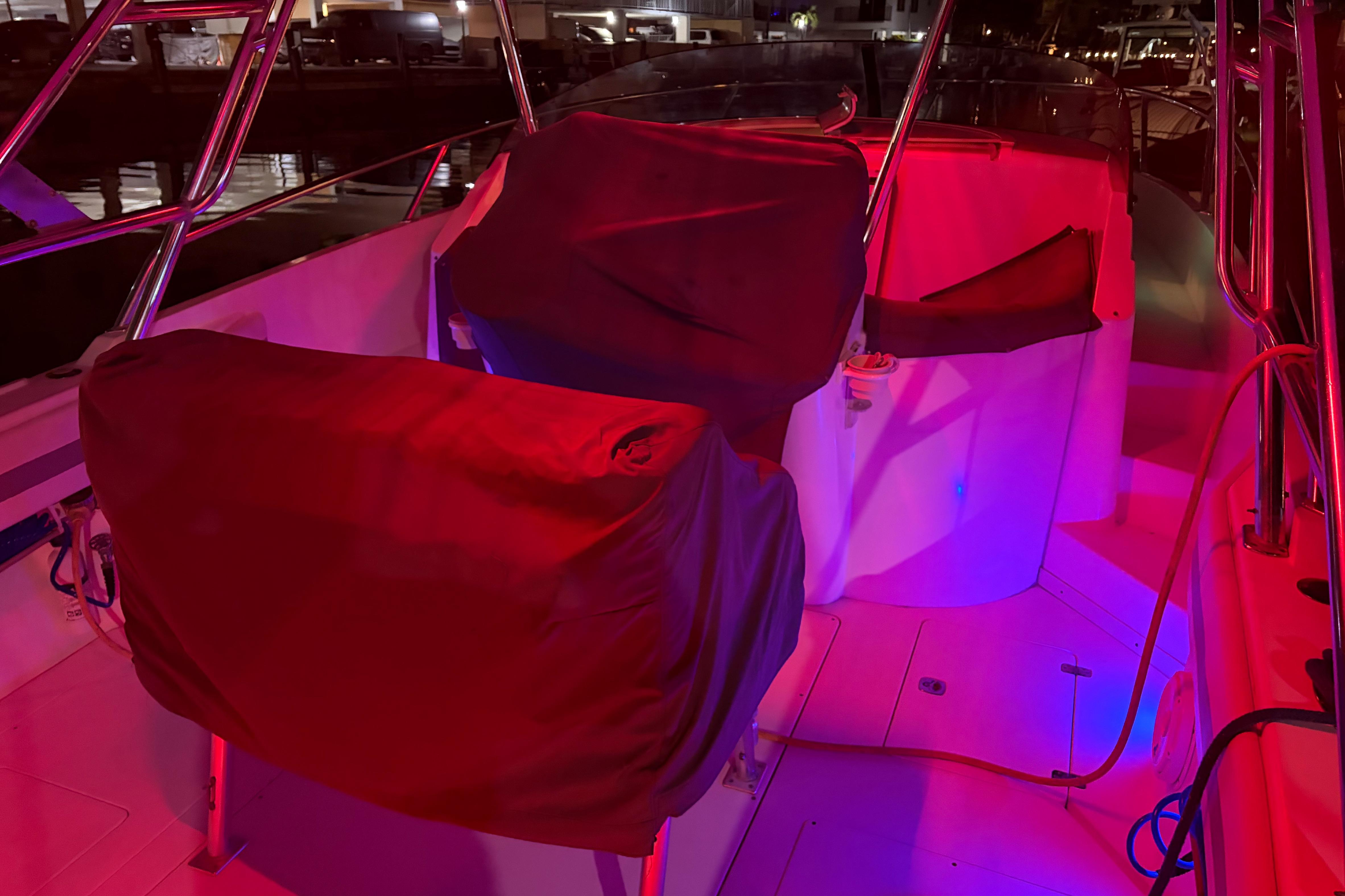1998 Intrepid 339 Walkaround boat interior with red lighting at night.