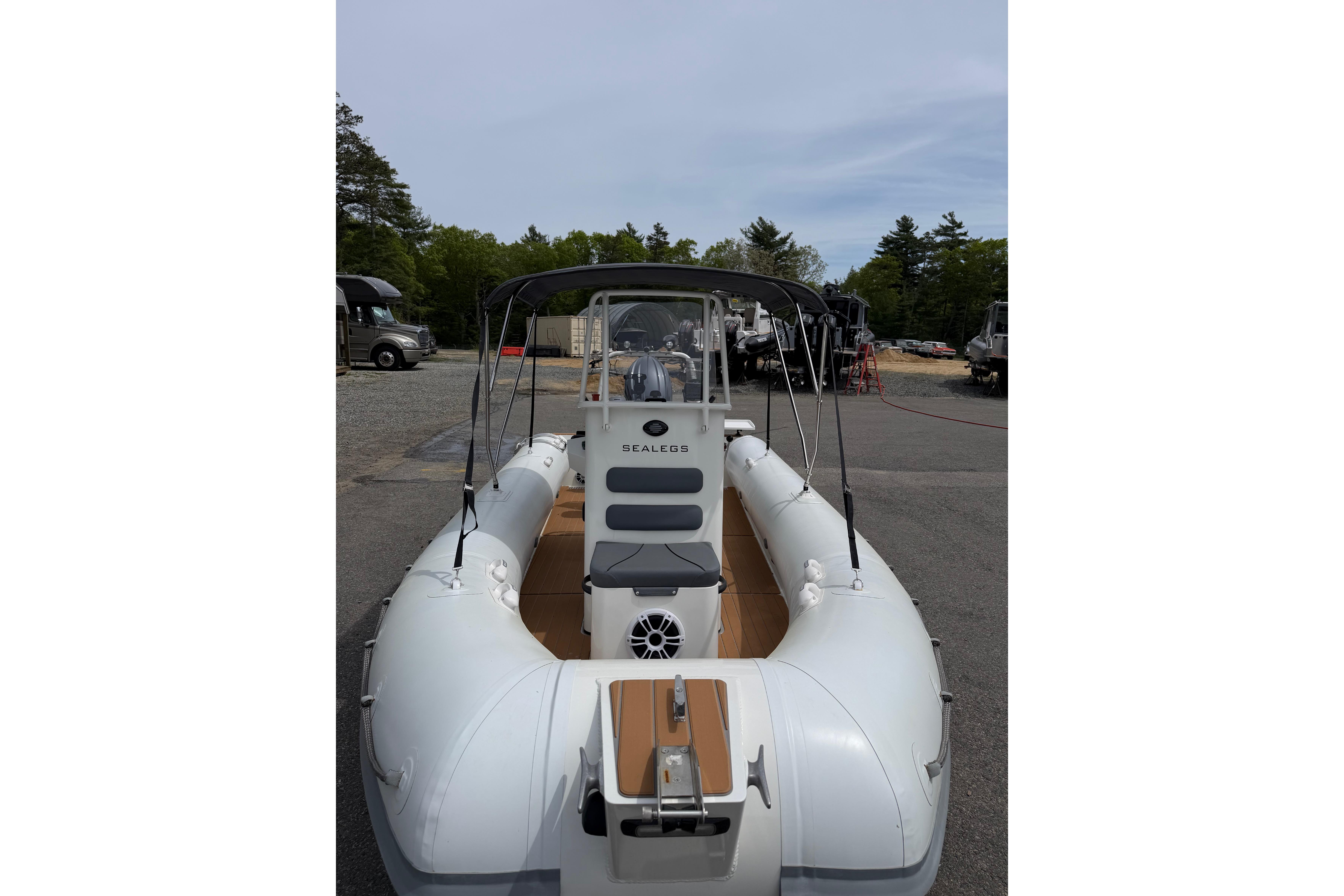 2024 Sealegs 7.1m RIB boat with canopy, parked outdoors on a sunny day.