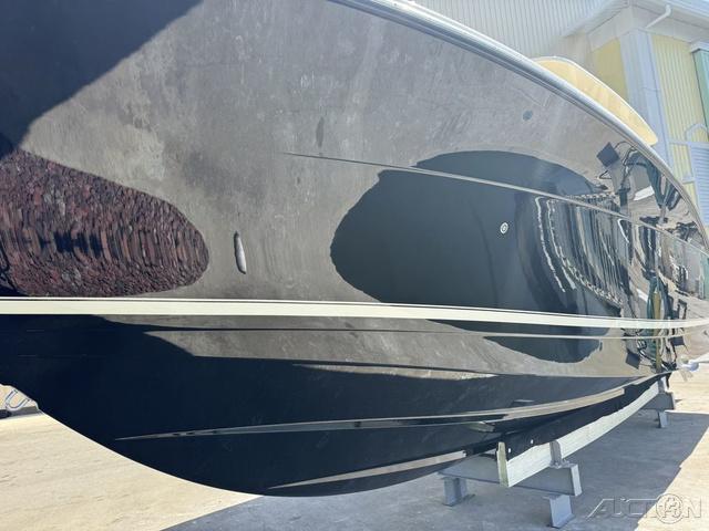 2022 Scout 330 LXF boat with sleek black hull on display.