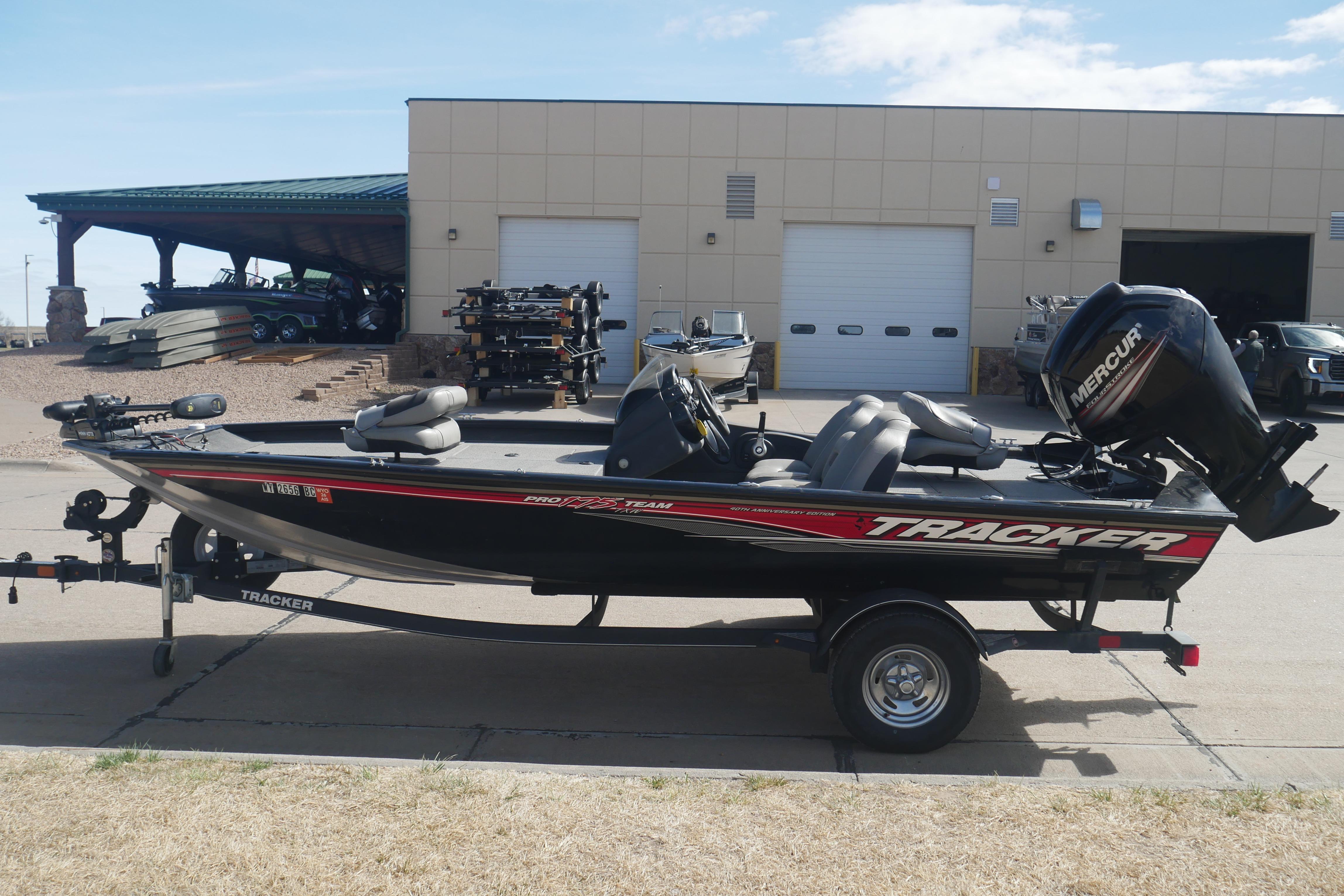 2018 Tracker Pro Team 175 TXW fishing boat with Mercury engine, parked outdoors.
