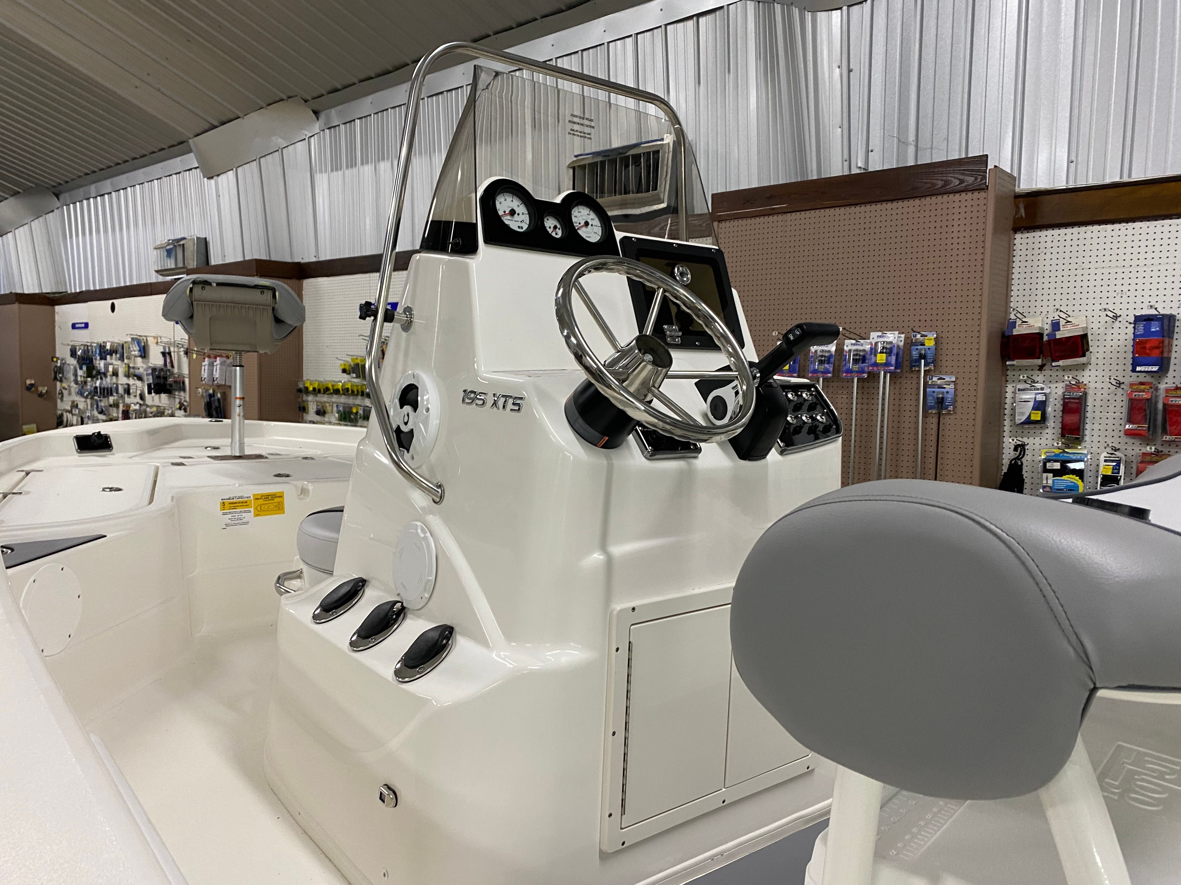 The image shows the helm of a 2021 NauticStar 195 XTS boat in a showroom.